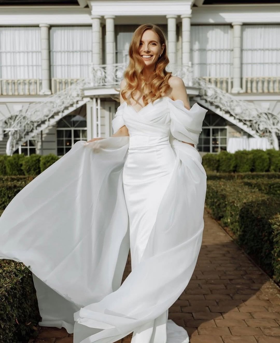 The Vetta Gown: Effortless allure with a touch of modern grace.
One of our newest arrivals &mdash; a gown that combines sleek minimalism with soft, romantic draping. Flowing organza sleeves and a clean silhouette create a look that feels both timeles