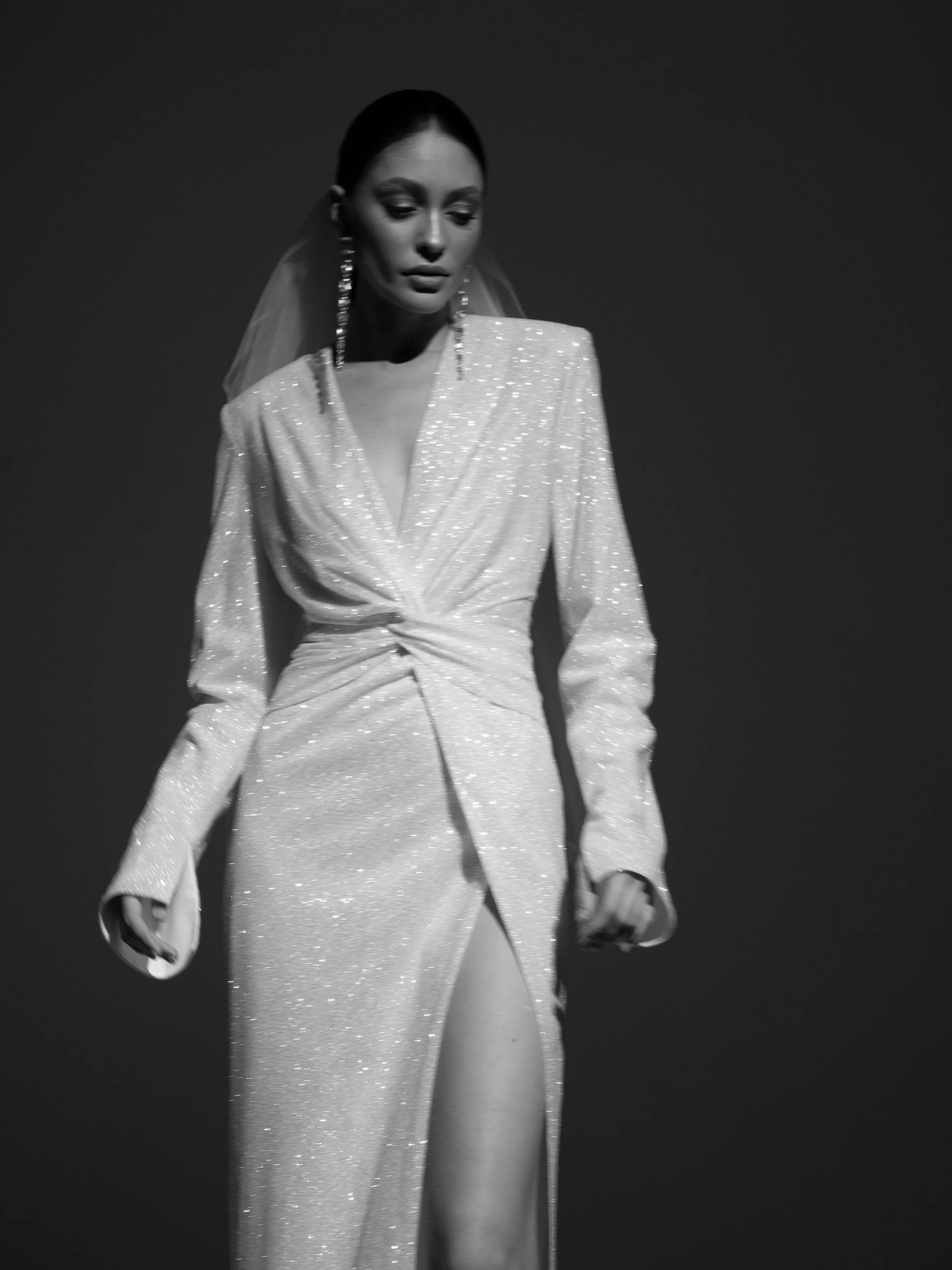 The Mazunte Wedding Gown: Chic, Shimmering Elegance.
Turn up the glamour with The Mazunte, a dazzling reception wedding dress designed for the bride who&rsquo;s ready to shine. With its shimmering fabric, statement shoulders, and sultry silhouette, t