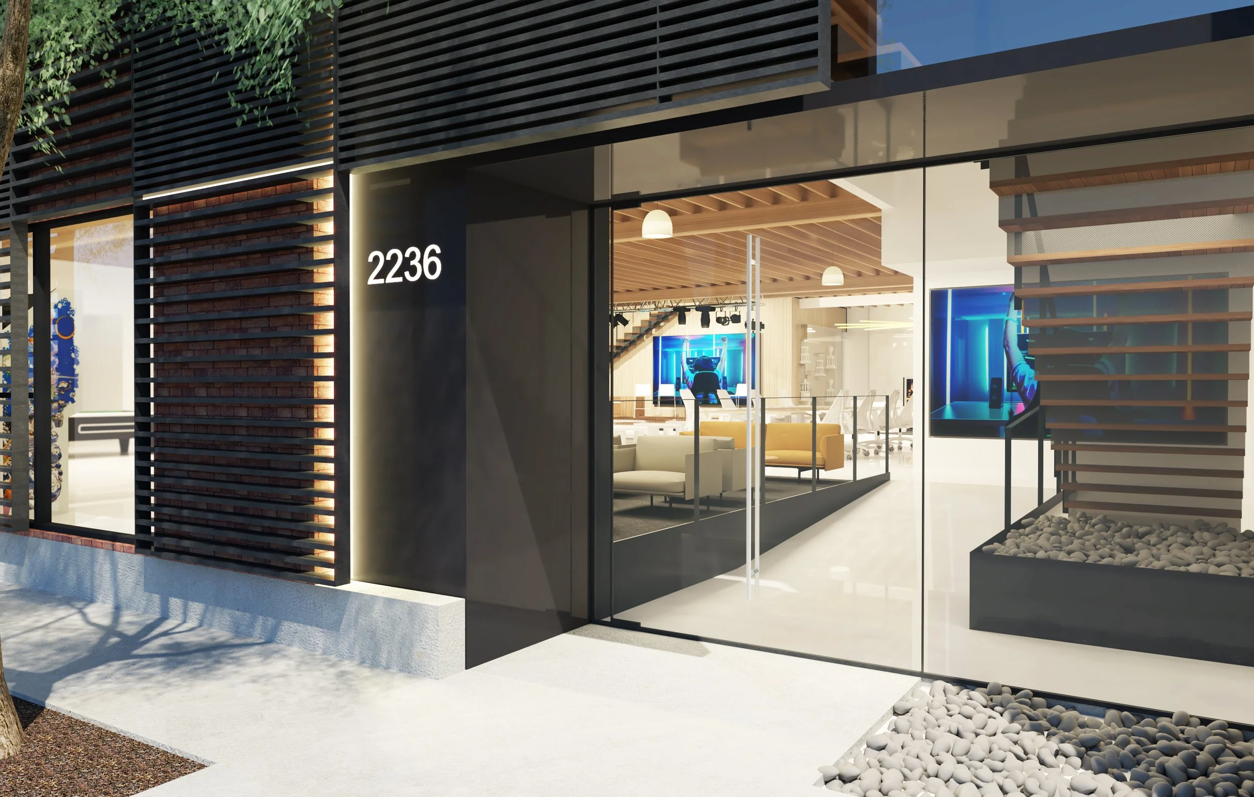 Modern office building with the number 2236 on the exterior wall, glass doors revealing a well-lit interior with seating, digital screens, and conference area.