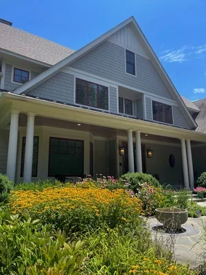 Woodland garden with flowering trees, and native plants in a conservation landscape designed and installed by Native Conservation Landscaping (formerly Native Roots) in Great Falls, Virginia