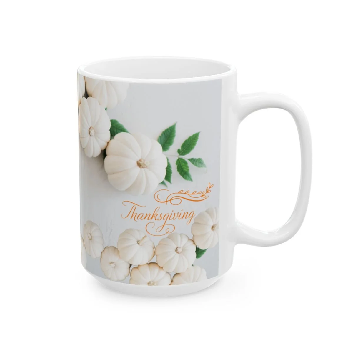 White pumpkin coffee mug with Thanksgiving script and decorative accents.