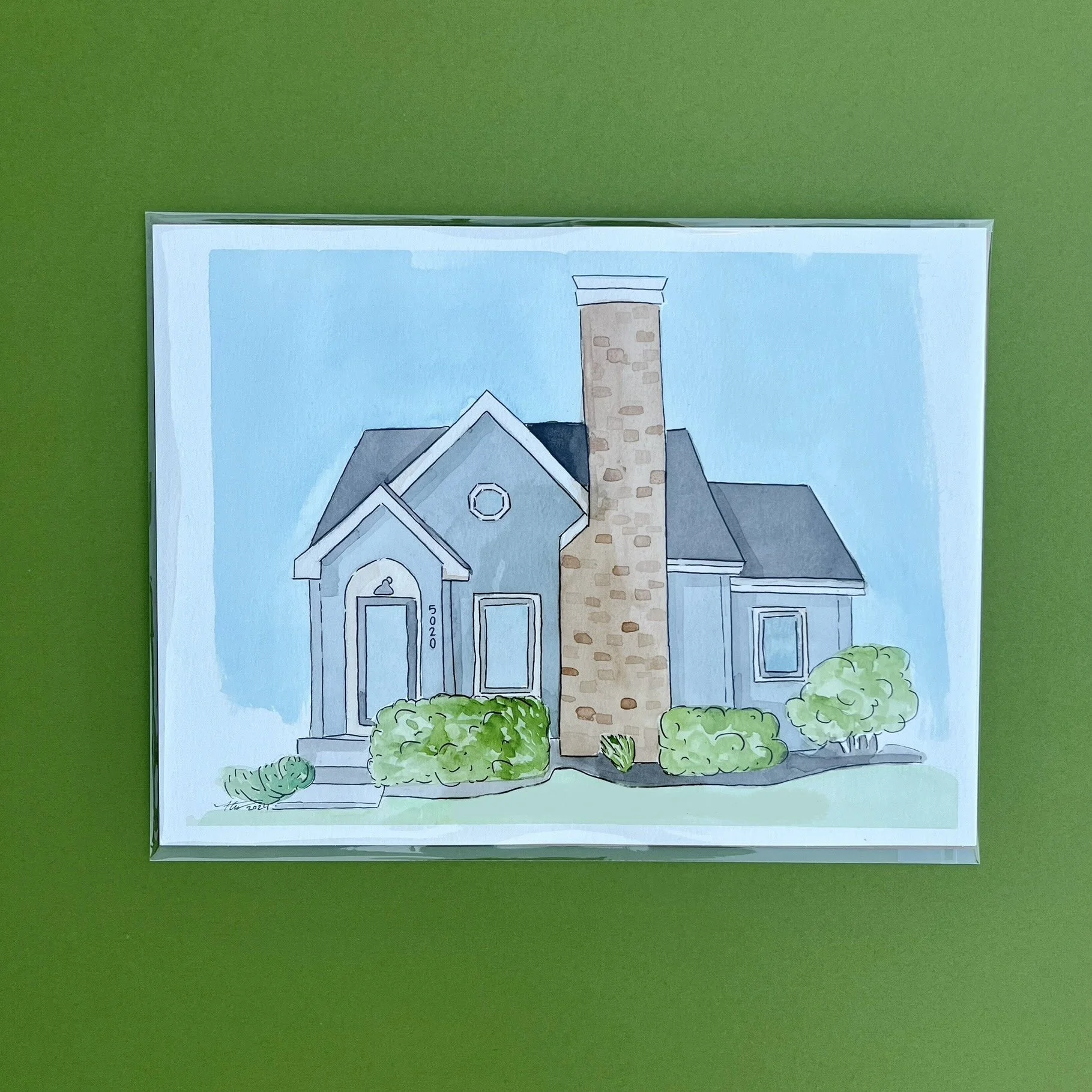 Illustration of a house with a blue exterior, a tall stone chimney, and bushes in front, on a green background.