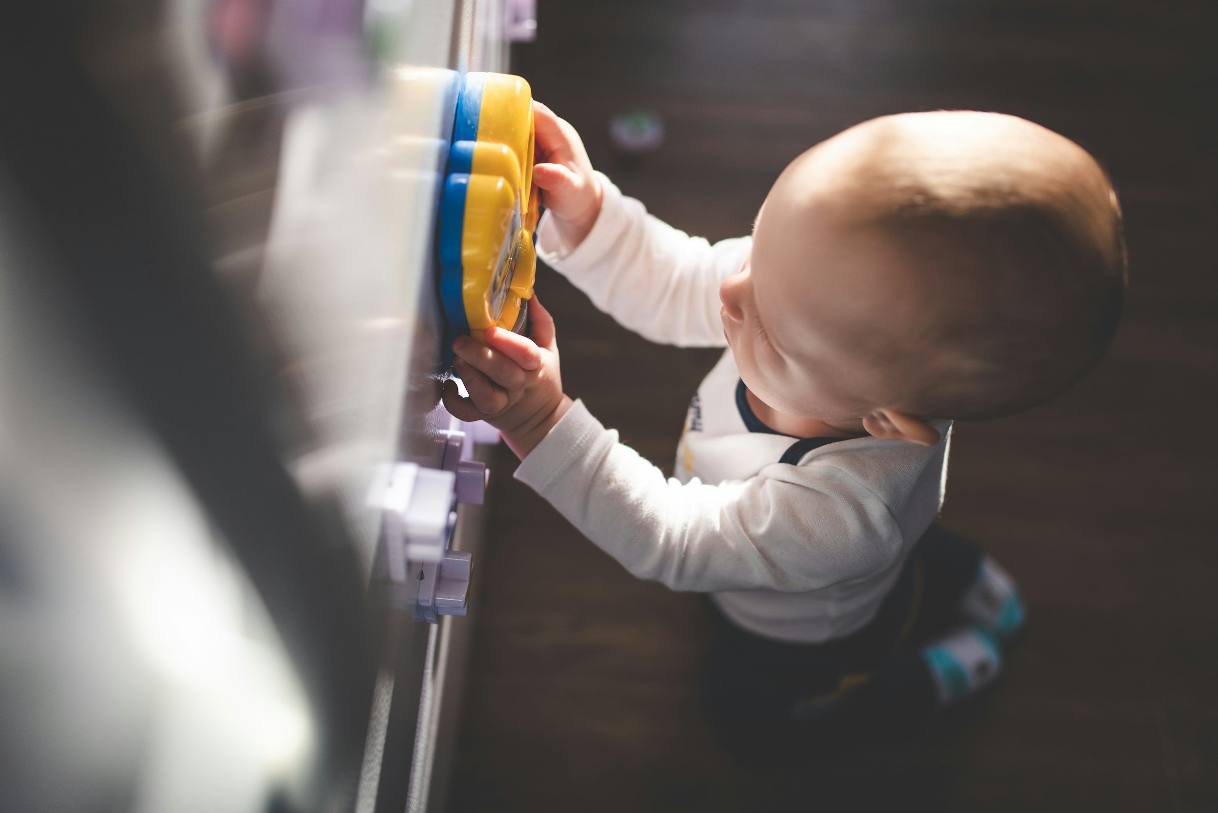 Baby playing with toy featured in a blog called Are IVF Babies More Special