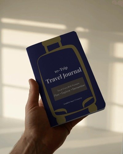 Person holding a 10-Trip Travel Journal from Grateful Heart Company.
