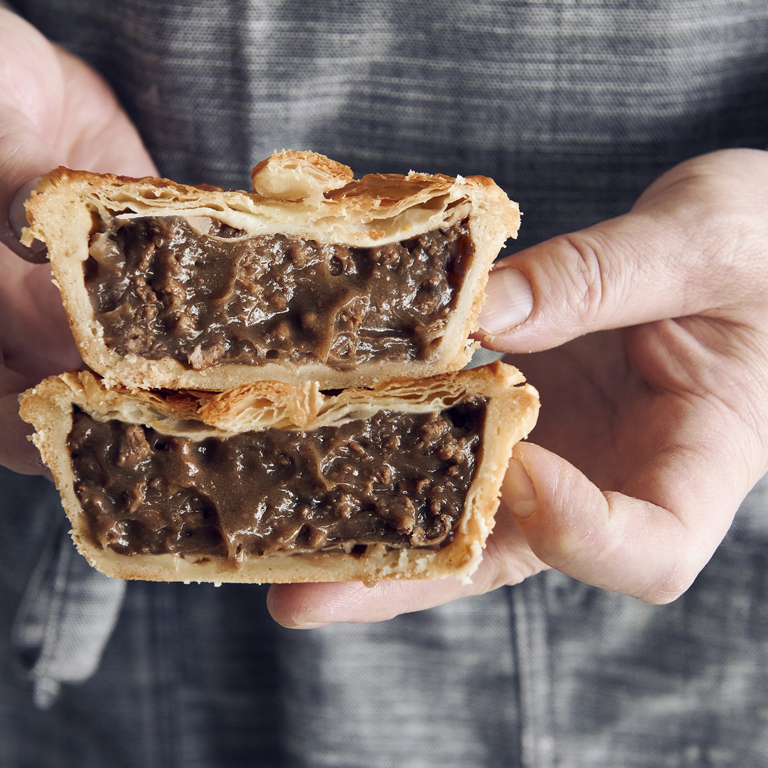 Aussie Beef Pie with flaky puff pastry top, crusty base , and juicy meat filling.