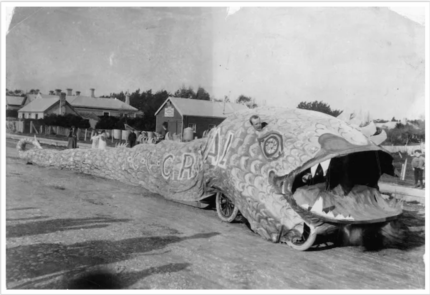 Dragon float from the Invercargill Cycling Club parade. Greig, J :Photographs of two men in a monkey suit on a bicycle and of a parade dragon. Ref: 1/2-062600-F. Alexander Turnbull Library, Wellington, New Zealand. /records/22730422.  Promotional veh