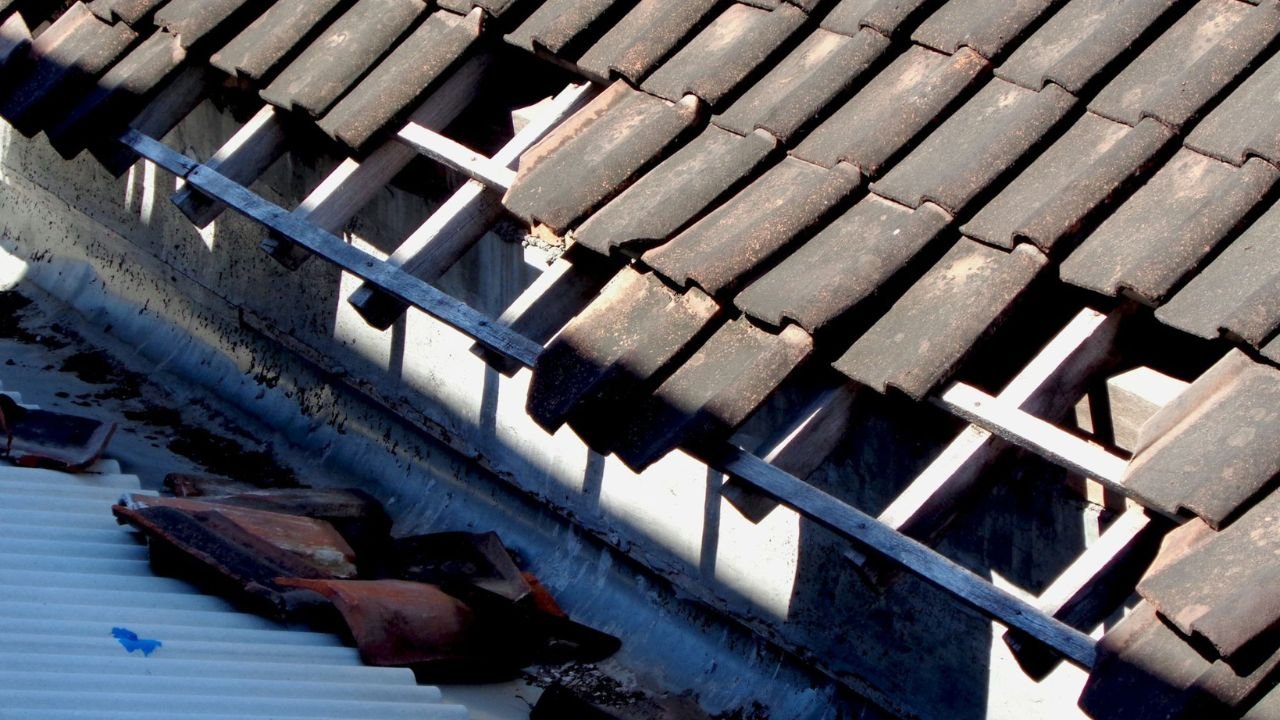 Damaged roof edge and gutter area showing signs of water intrusion.