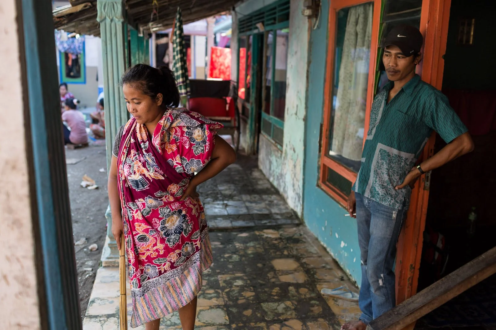 April 28, 2014 - Indramauy (Indonesia). Kanipah and her husband Samudi in front of their home. Kanipah is familiar with migration, and has left home three times in the past, working in Kuwait, Abu Dhabi and Qatar as a domestic worker. © Nicolas Axelr