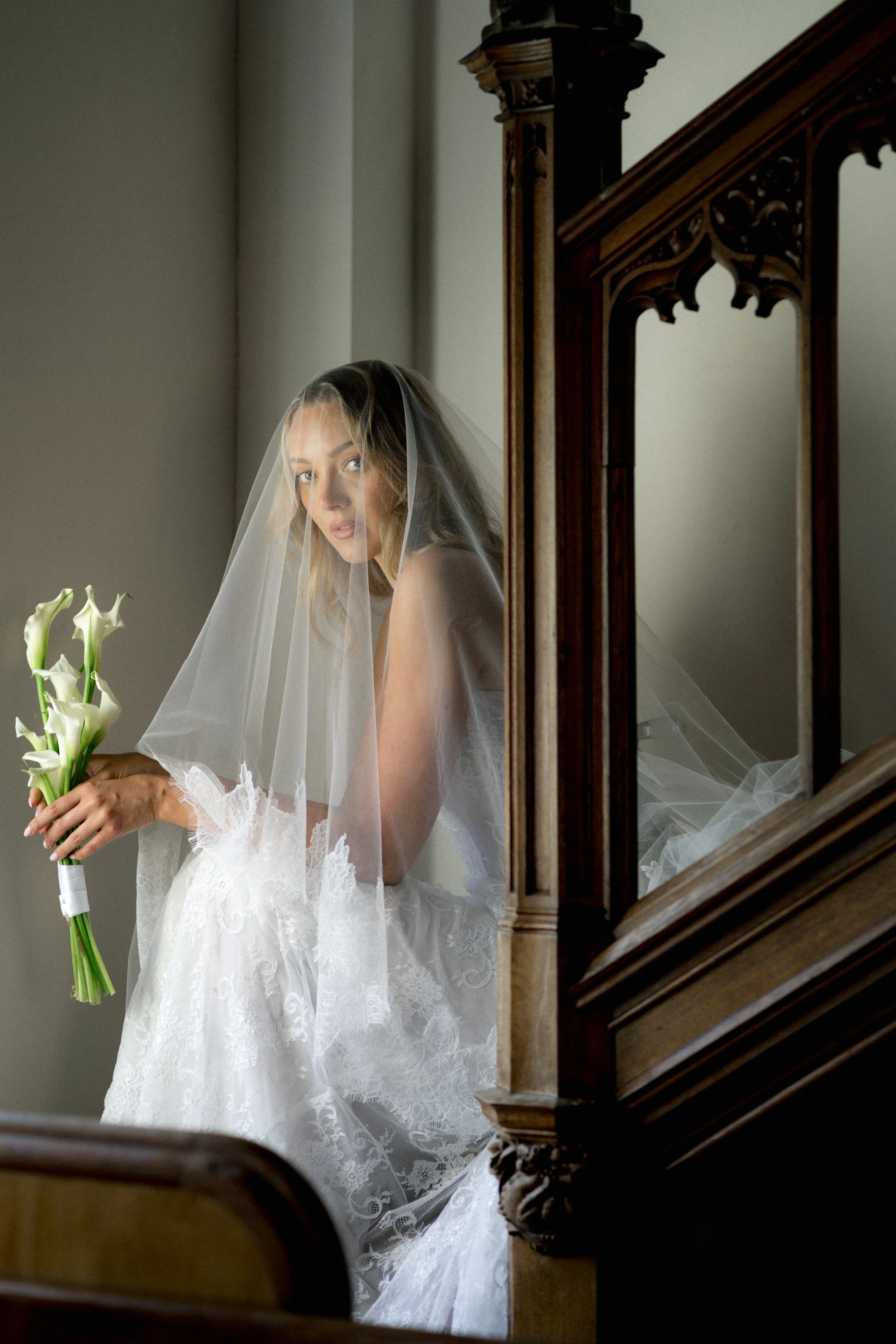 Bride holding a calla lily bouquet at Thicket Priory