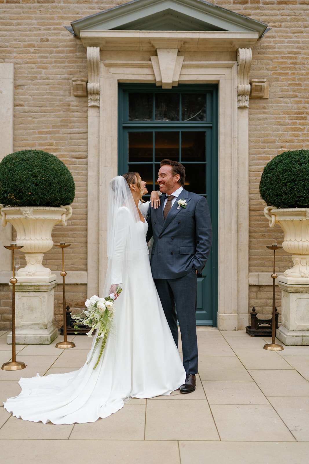 Bride and groom stood in doorway of Hotham Hall Estate