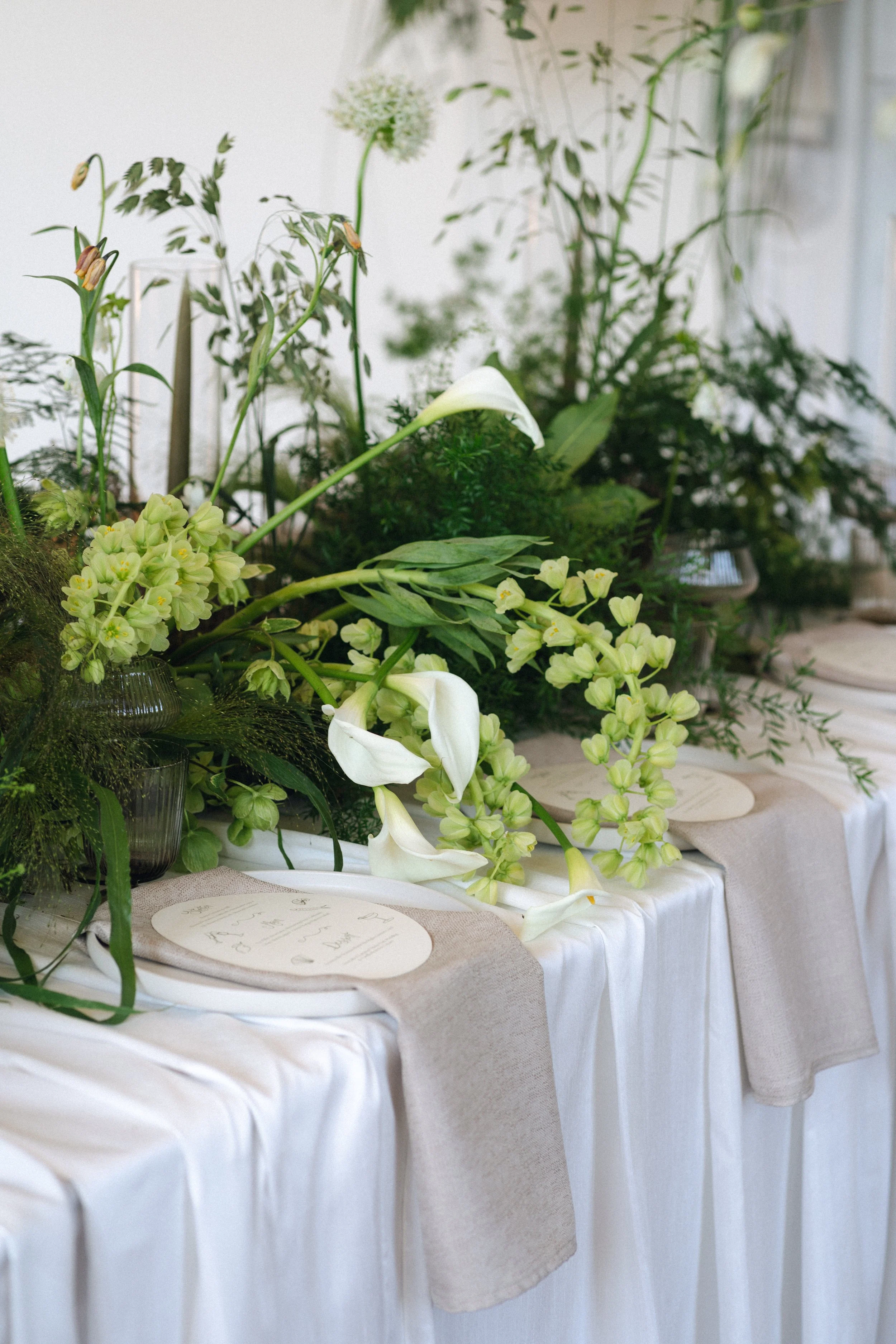 Tablescape for wedding reception at Thicket Priory.  Including calla lilies, grasses and alliums