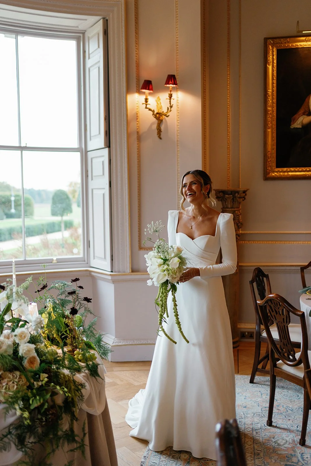 Bride looking at wedding flowers by Bloom and Bridal at Hotham Hall Estate