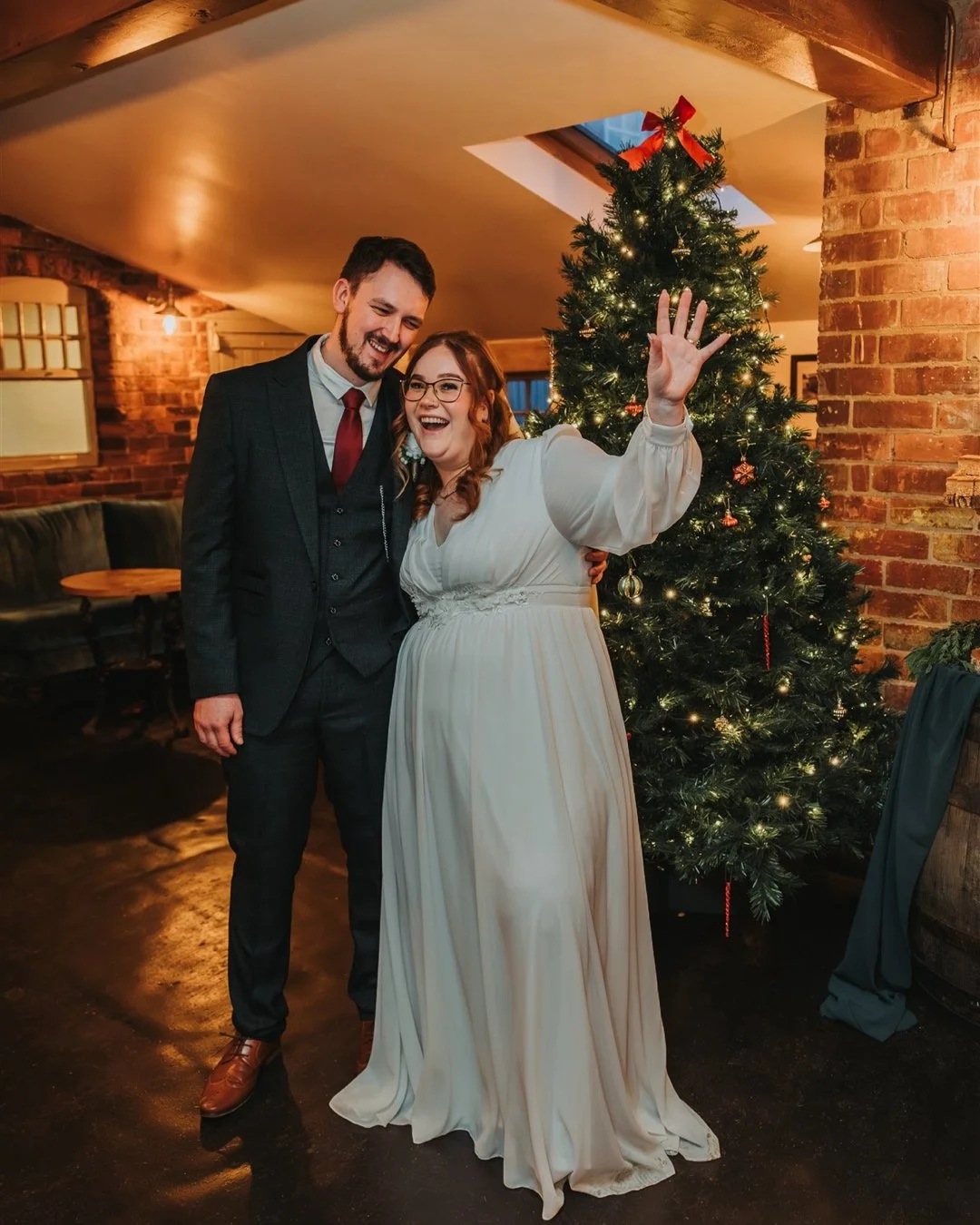 Bride & Groom having a couple photo near a Christmas Tree.