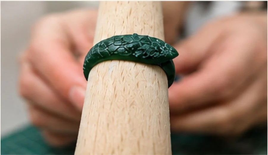 Wax ring being refined and smoothed with jewellery carving tools.