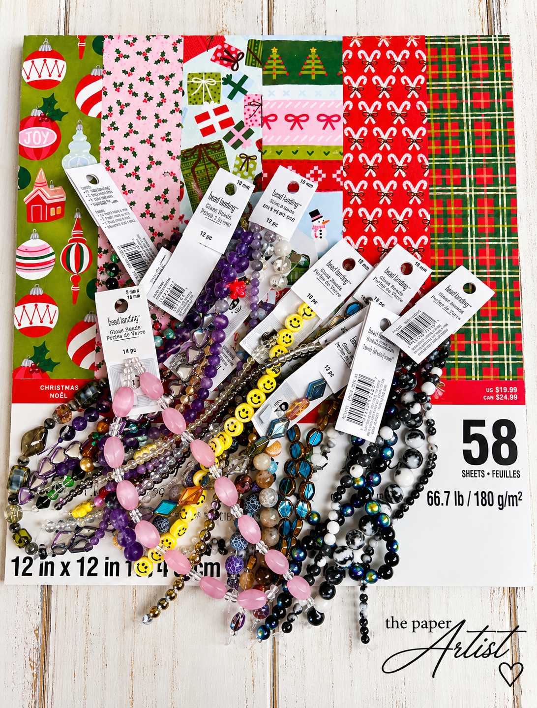 Michael's bead sale haul featuring colorful jewelry making beads and Christmas scrapbook paper.