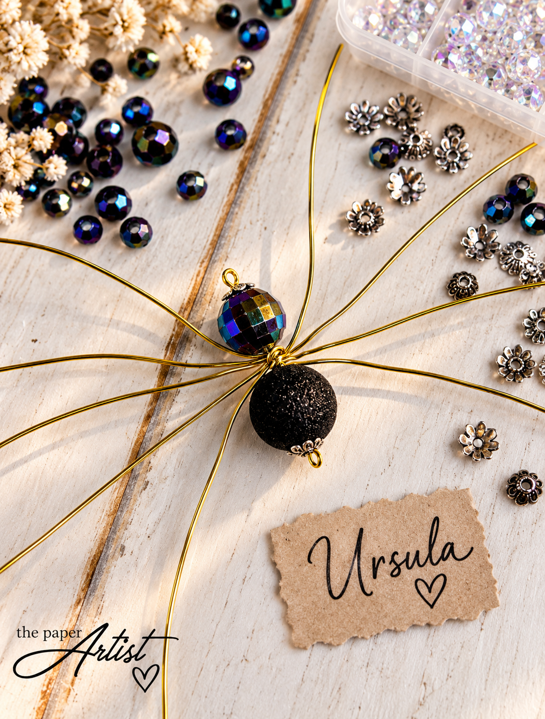 Eight gold wire spider legs spread into position before adding beads