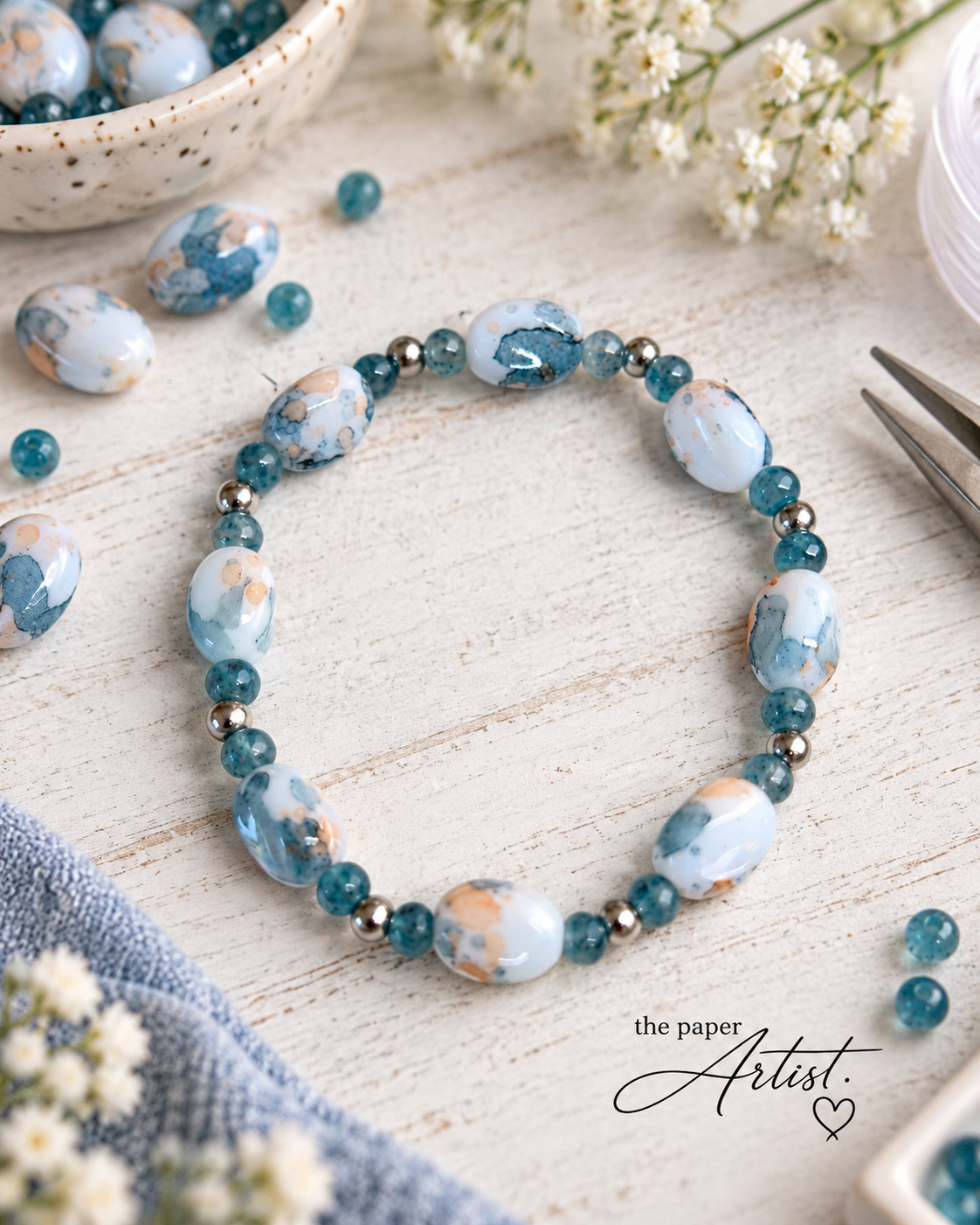 Two handmade stretch beaded bracelets featuring coordinating marbled focal beads, styled with different blue and peach accent bead combinations for a This or That jewelry design comparison.