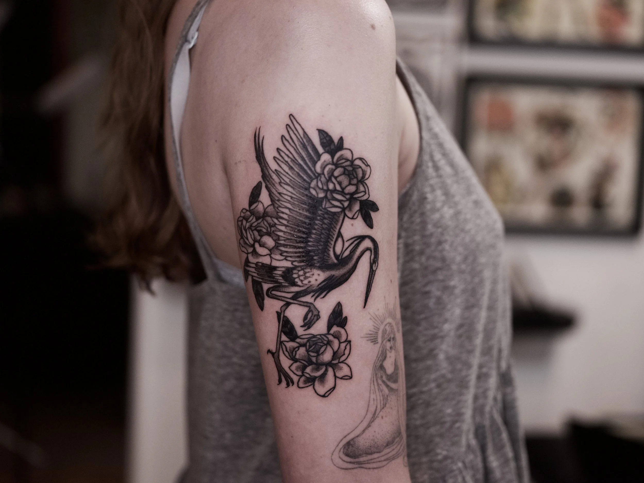Tattoo of a crane and roses in a black and gray, american traditional style. Philadelphia