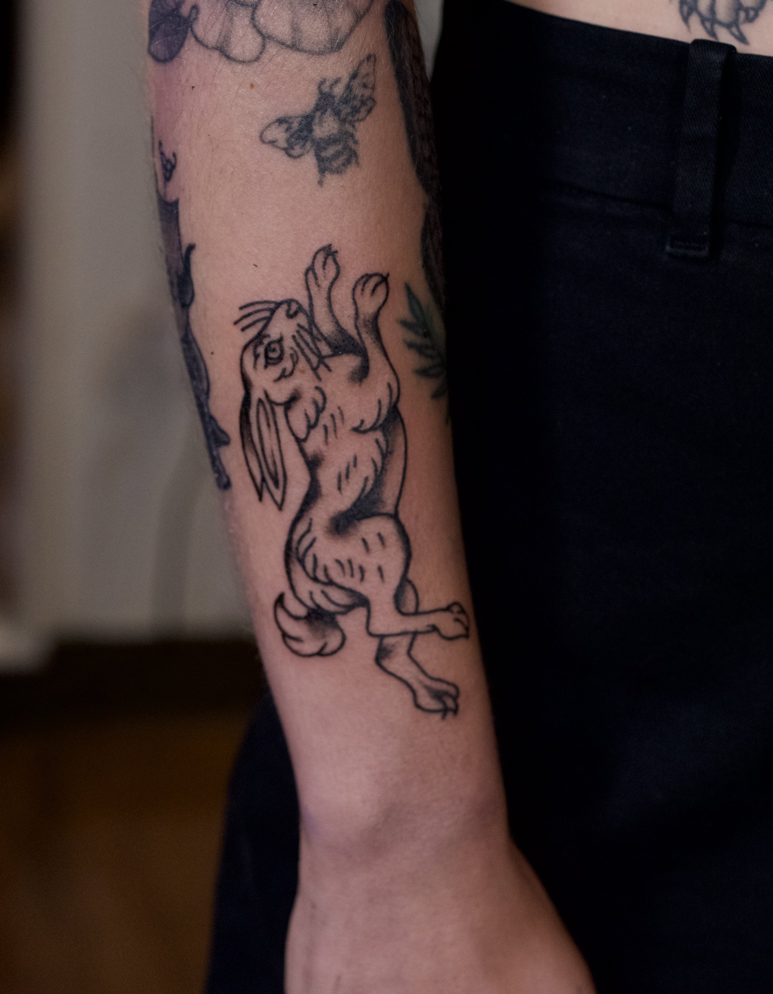 Tattoo of an american traditional bunny in black and gray. William-Adolphe Bouguereau