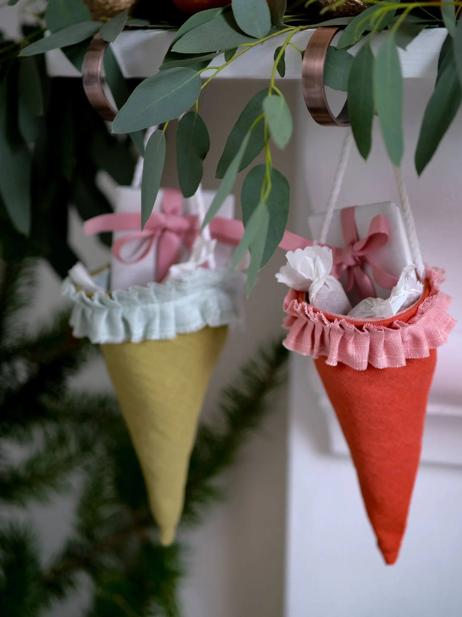 Reusable Victorian Christmas gift cones for hanging beneath festive greenery, featuring delicate ruffled trim.