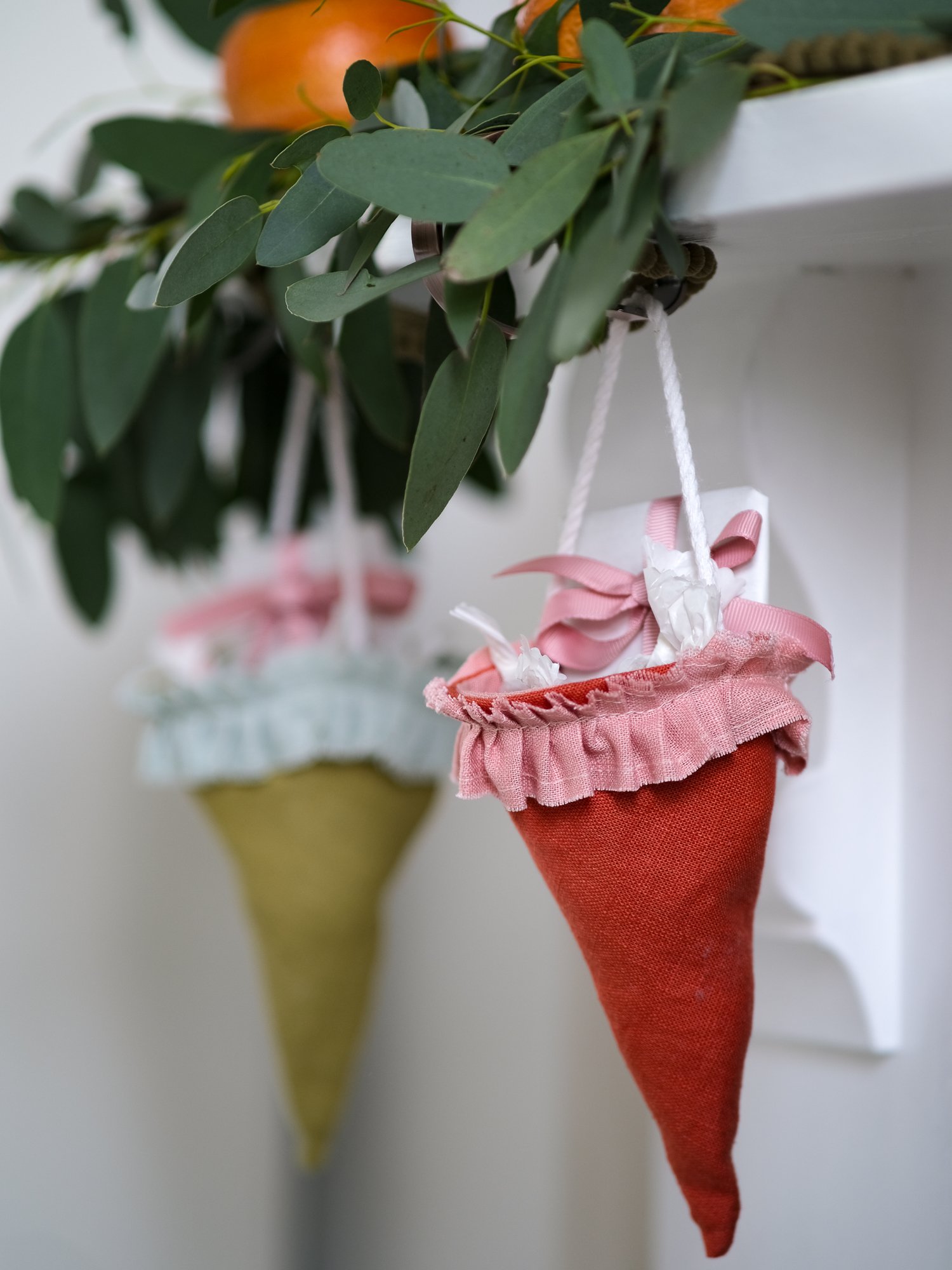 Reusable Victorian Christmas gift cones for hanging beneath festive greenery, featuring delicate ruffled trim.