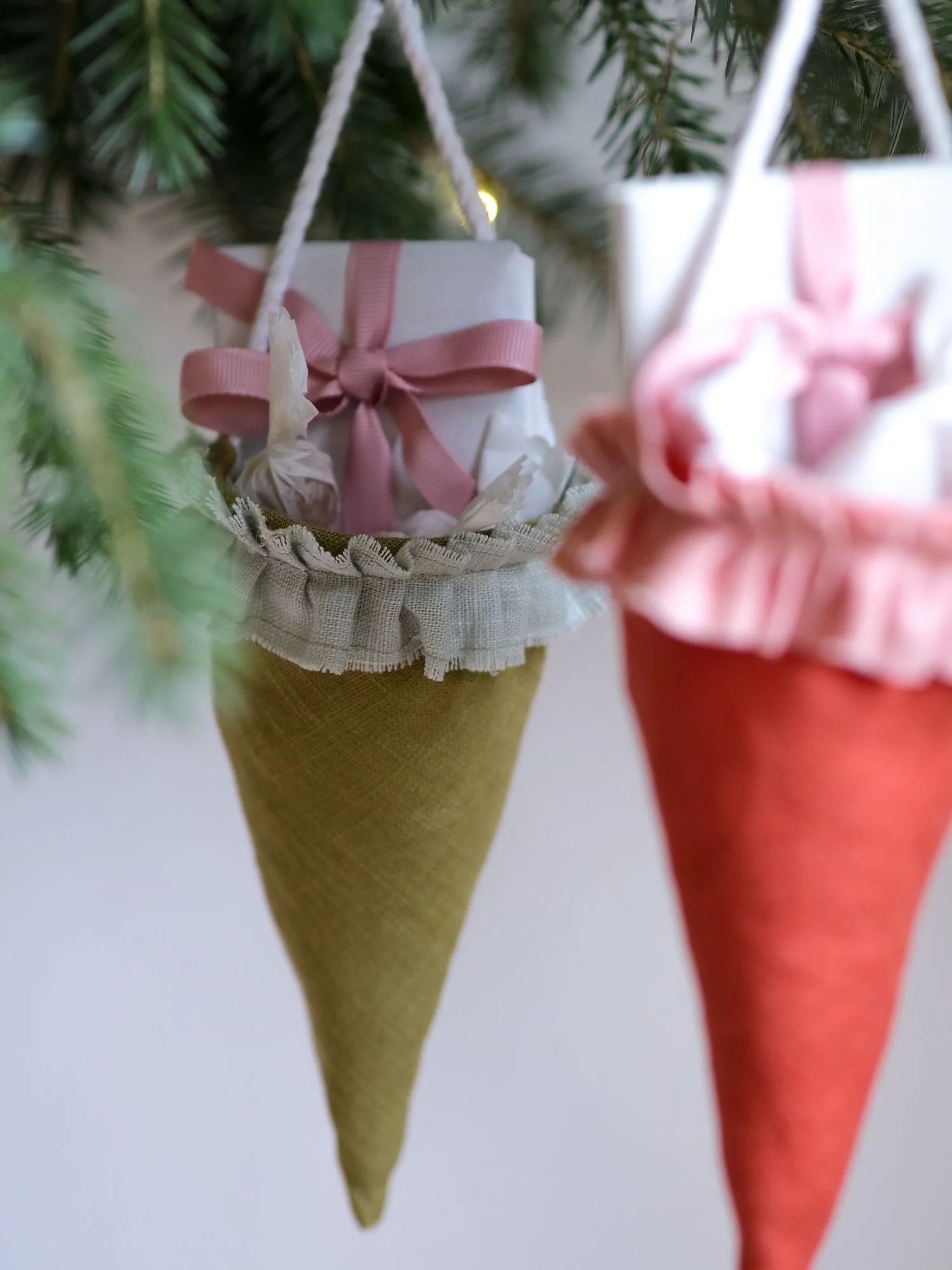 Reusable Victorian Christmas gift cones for hanging beneath festive greenery, featuring delicate ruffled trim.