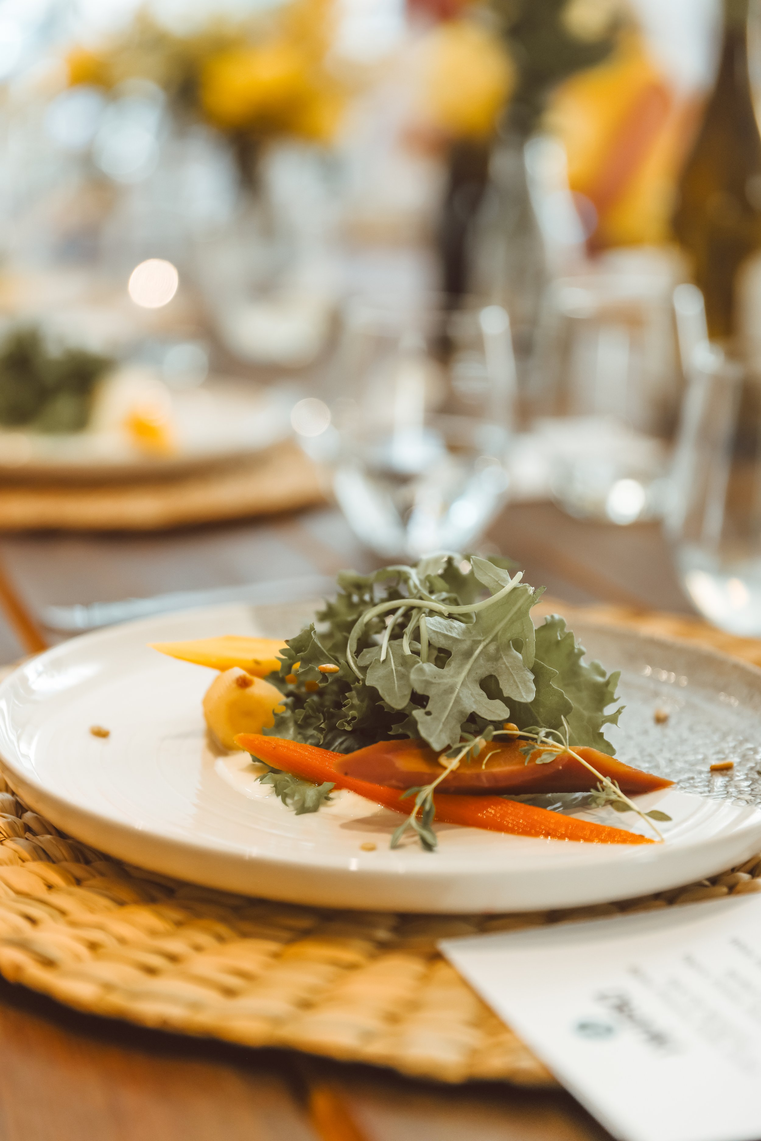 Elevated salad on a nice dinner plate setting. DistriktF Park City Event Space Rental.