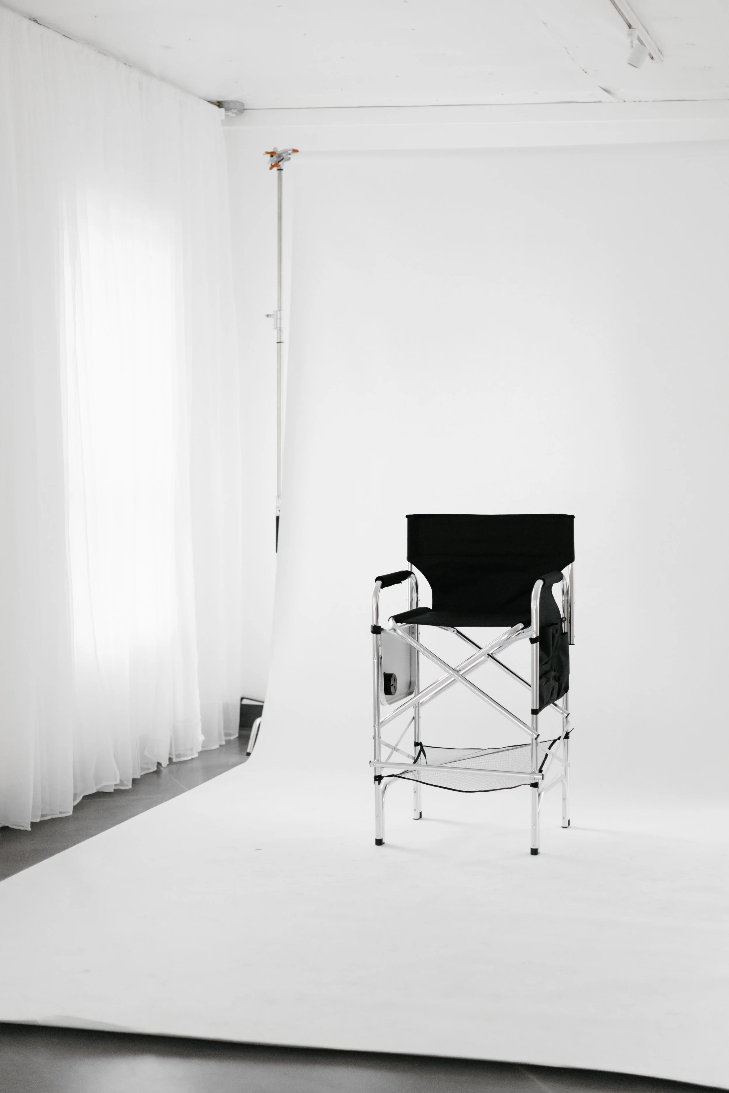 Empty chair sitting on a blank photo studio backdrop. DistriktF Park City Photo Studio Rental.