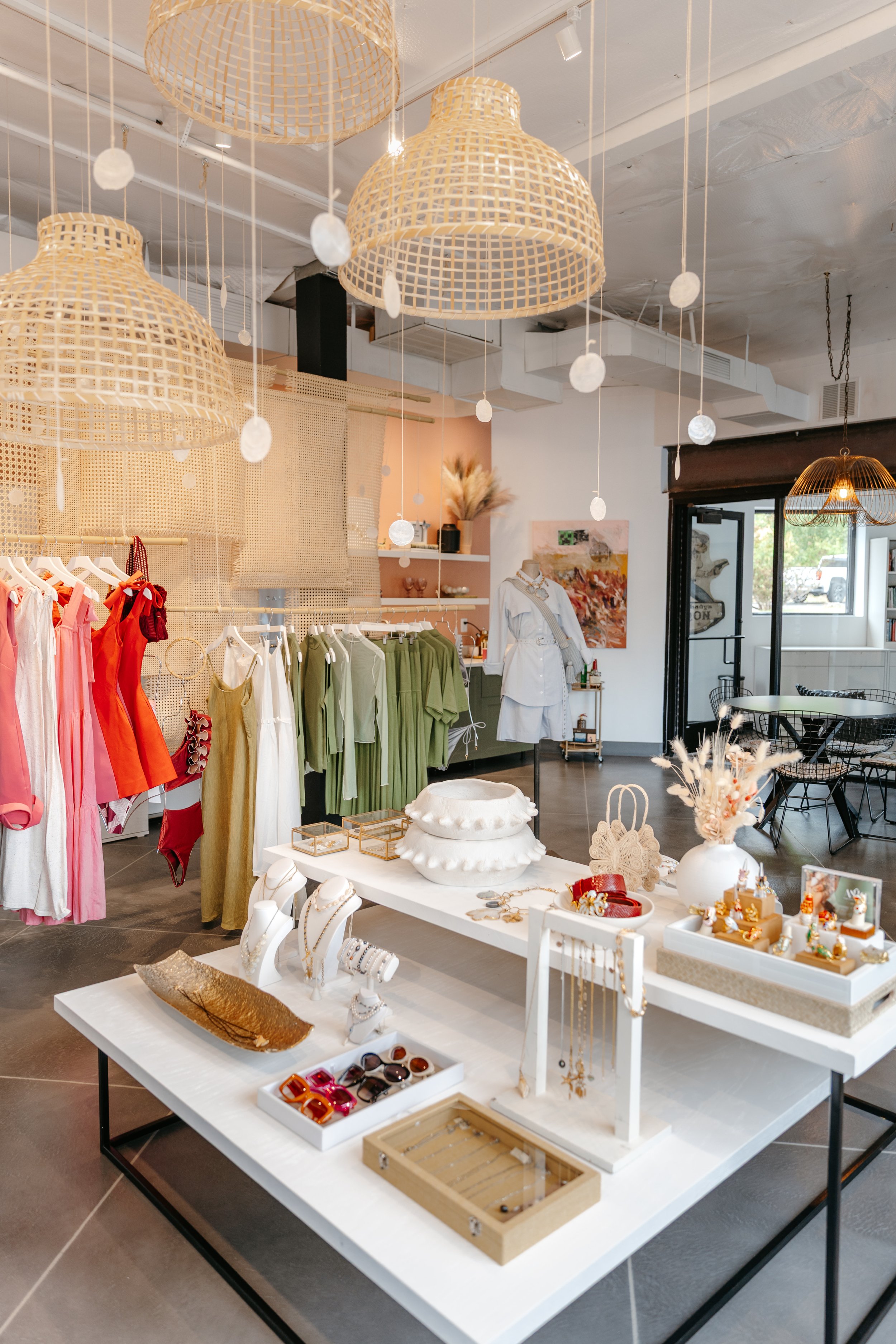 Brand pop-up display, featuring colorful clothing and custom fine jewelry in a bright and airy room. DistriktF Park City Utah Brand Pop Up Rental Space.