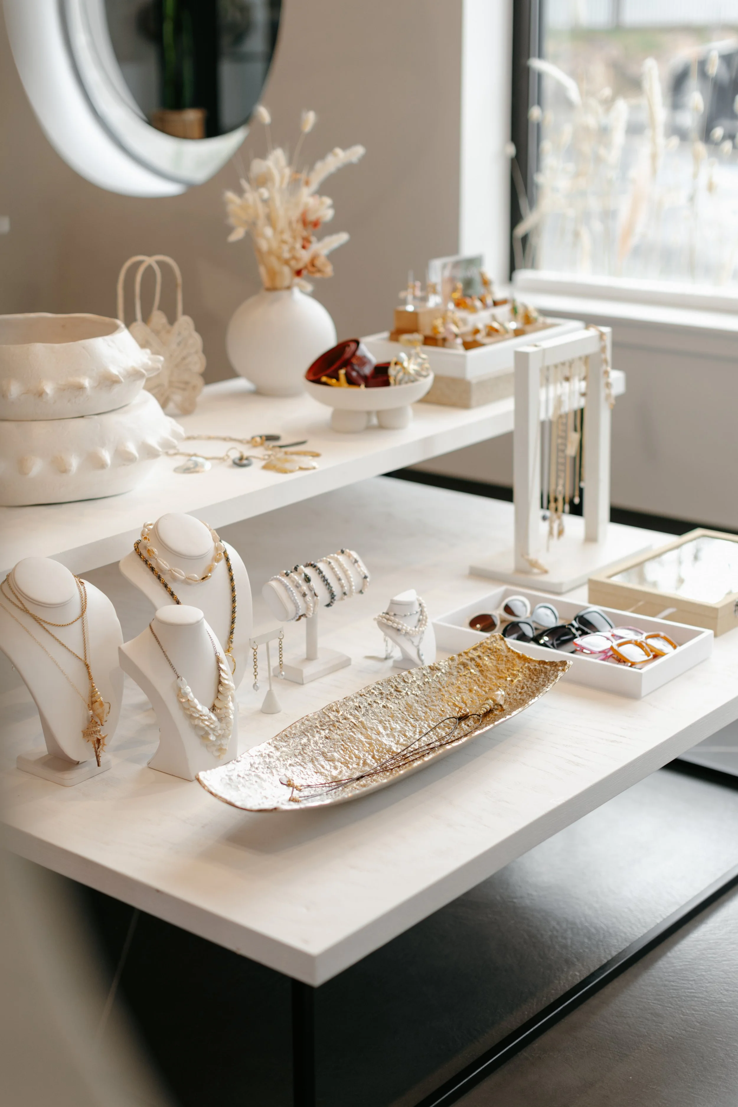 Custom handmade jewelry showcased in a bright room. DistriktF Park City Brand Pop-Up Rental Space.