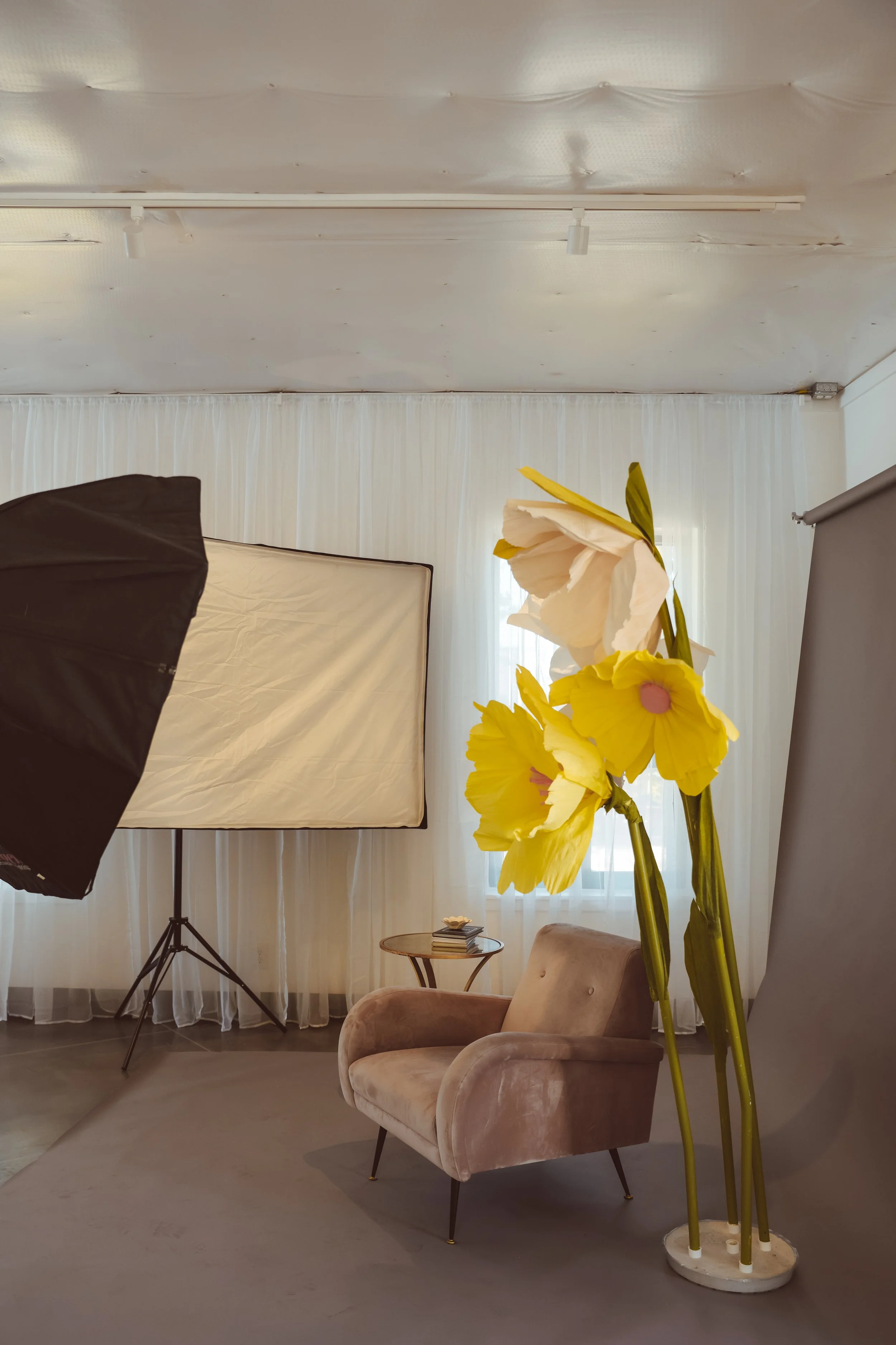 Photo Booth setup with large yellow flowers. Floral themed event. DistriktF Park City Event Space Rental.
