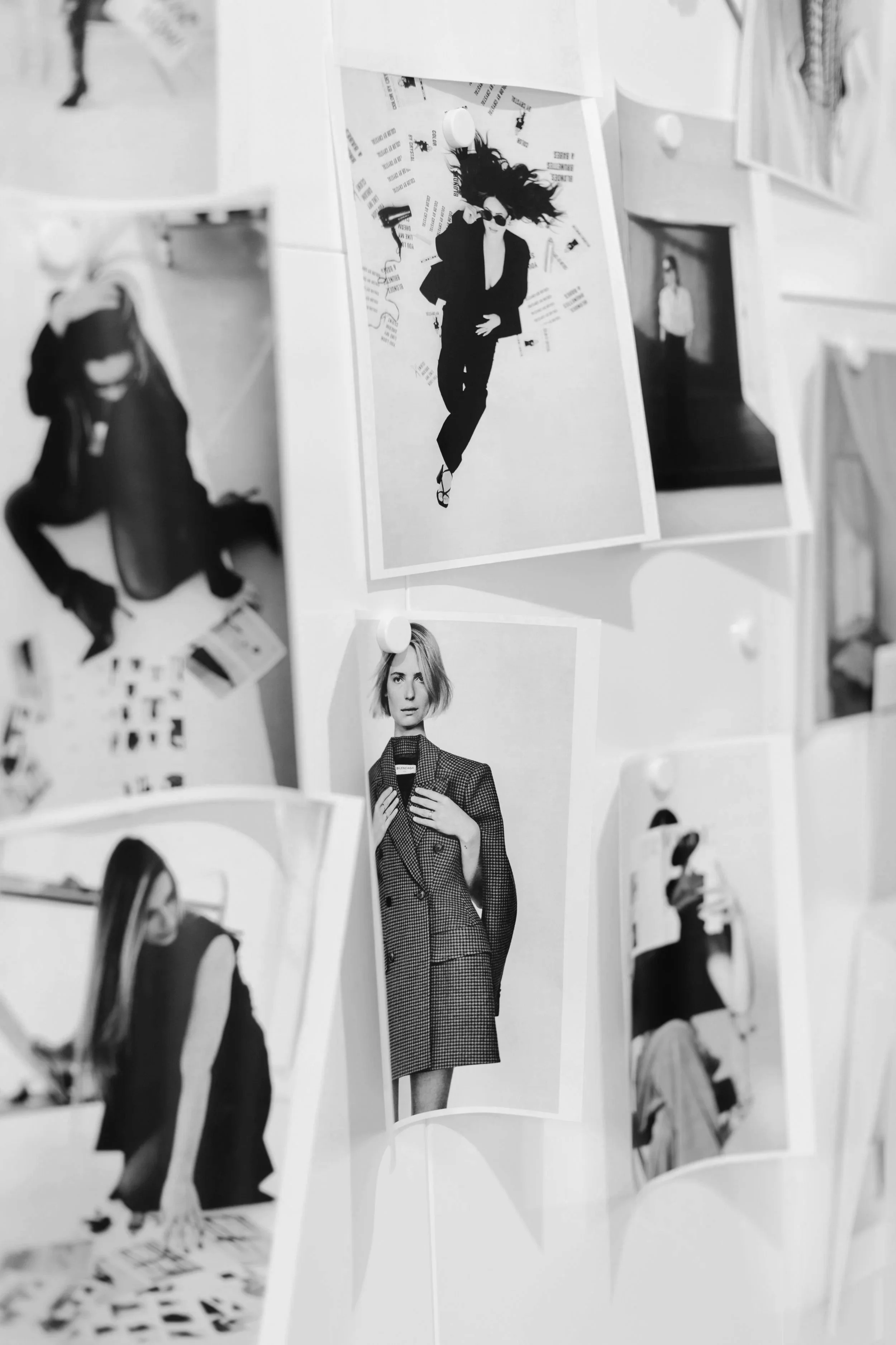 Printed images of photoshoot inspiration hanging on a wall. DistriktF Park City Photo Studio Rental.