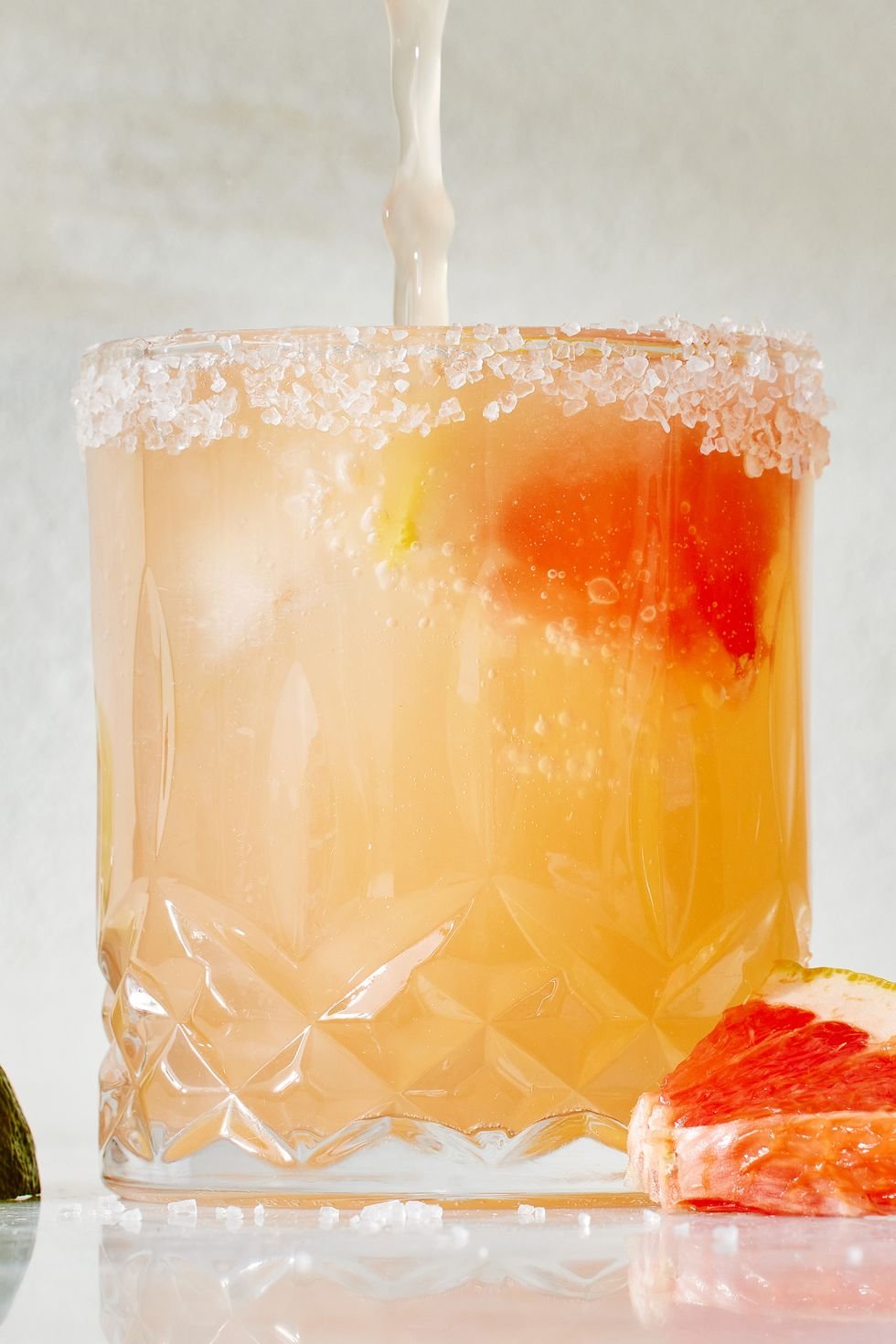 Paloma
Kosher salt
1 lime wedge
2 oz. grapefruit juice
2 oz. tequila
1/2 oz. simple syrup
Juice of 1/2 lime
2 oz. club soda
1 grapefruit wedge