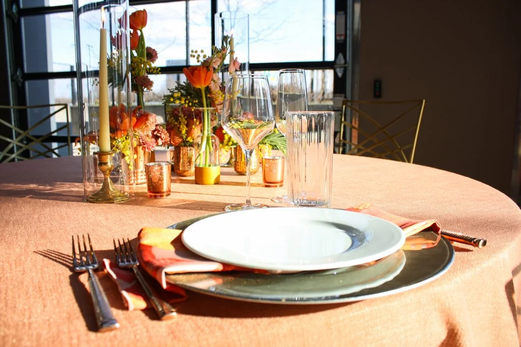 A wedding place setting is decorated to look like the colors of a sunset.