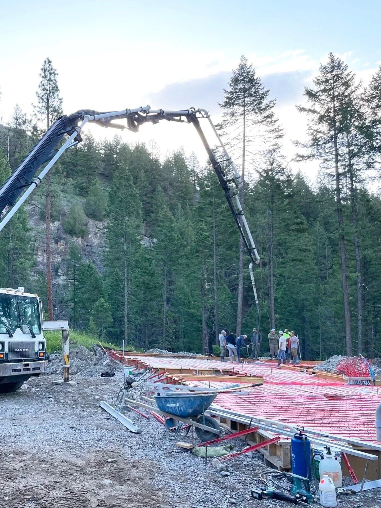 Radiant floor grid is installed and boom truck is pouring concrete