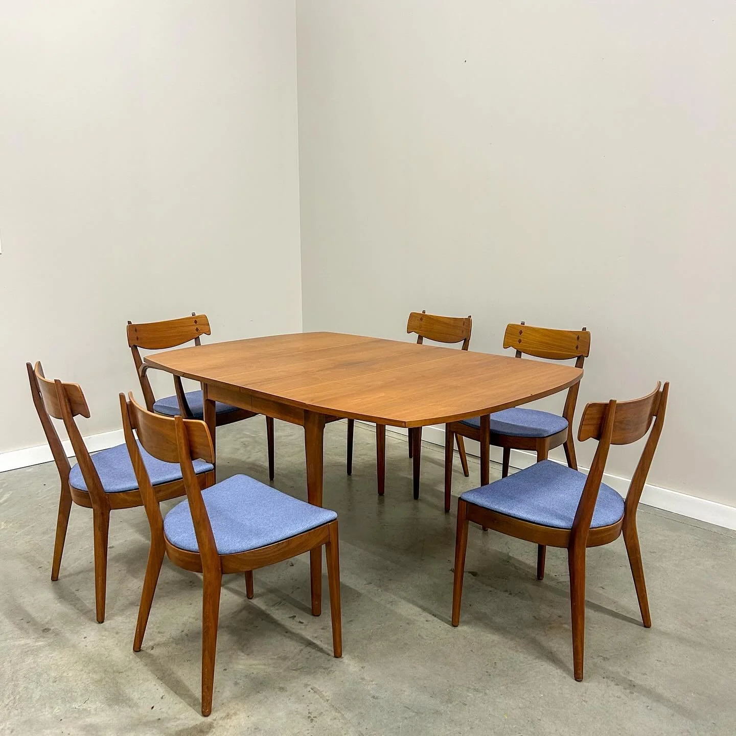 We couldn&rsquo;t just show off the chairs and leave you hanging. Here&rsquo;s the Drexel Declaration dining table by Kipp Stewart. Walnut legs, solid build, and a drop leaf design that saves space but expands to seat eight. Two leaves included, slig