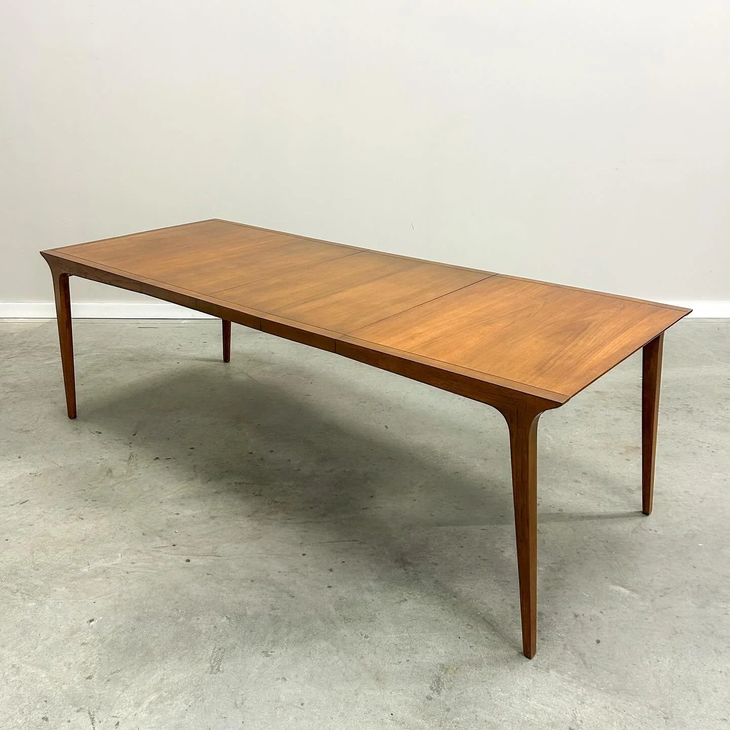 Refinished and ready for your next holiday dinner. This 1950s Drexel Profile dining table by John Van Koert has been completely brought back to life. Rich walnut grain, sculptural lines, and all the mid century charm. It&rsquo;s from the 50s and agin