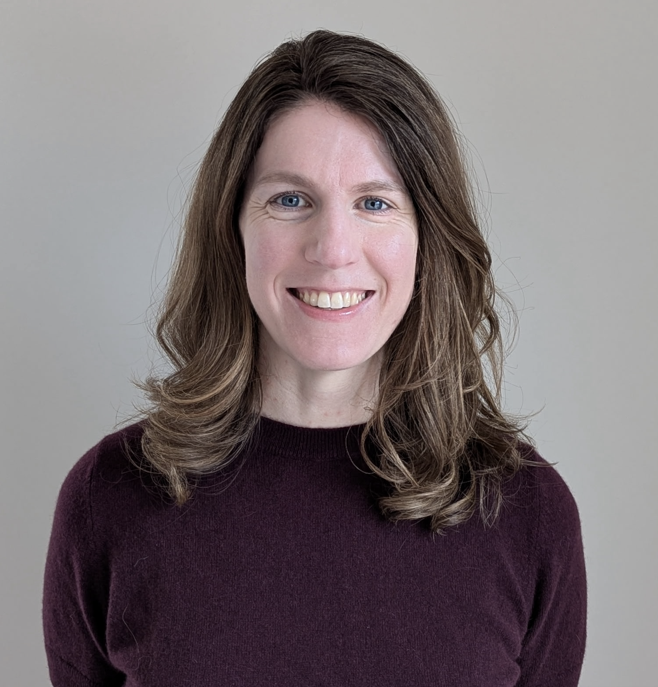 Photo of white woman with brunette hair smiling