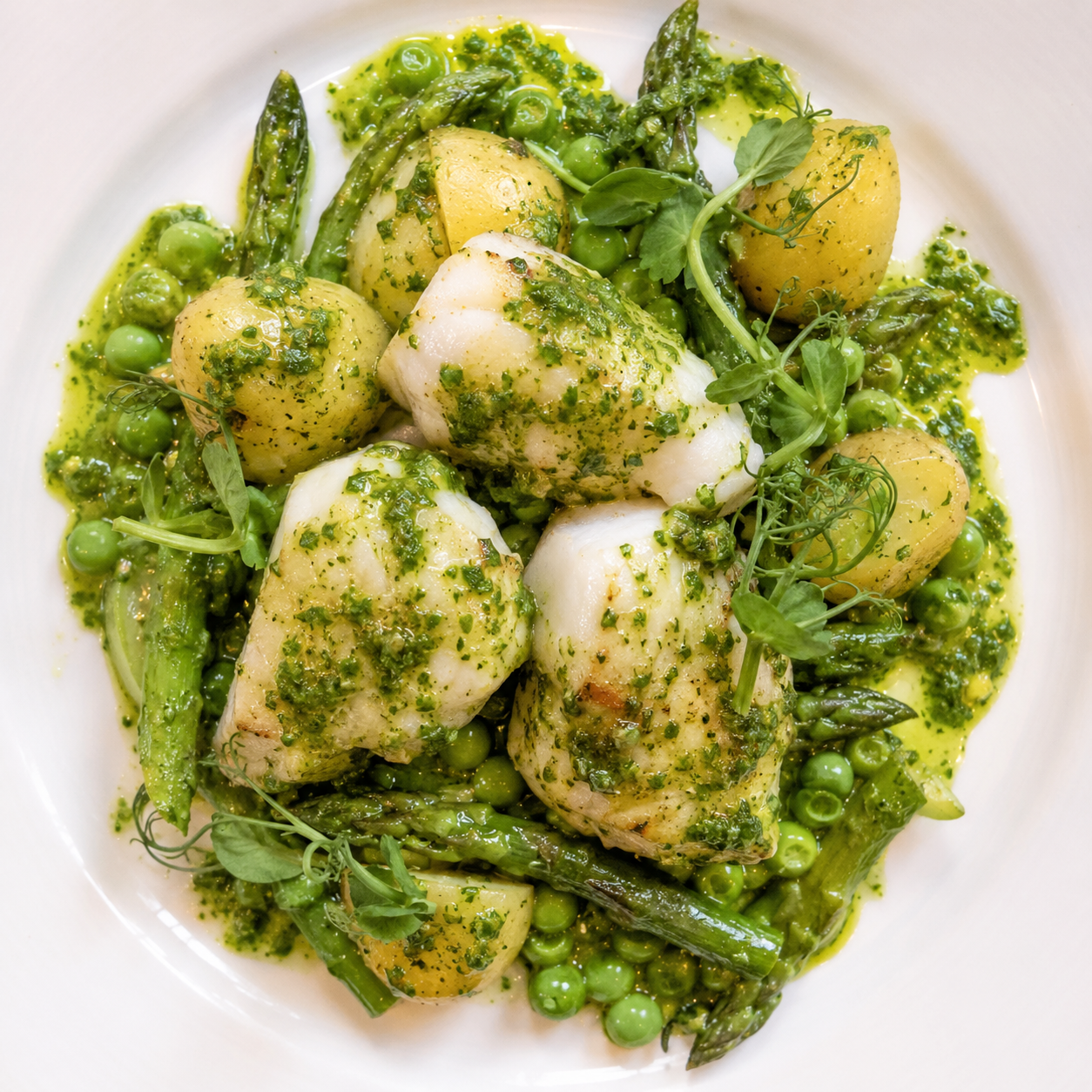 Poached Wild Fish (or fish Cheeks) in green sauce with seasonal vegetables