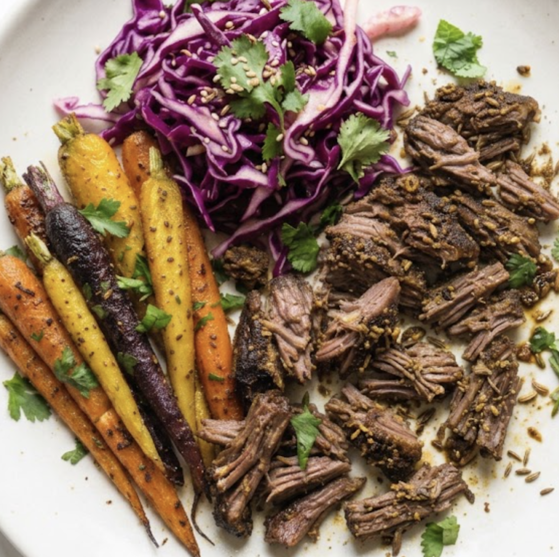 Tabil-Spiced Slow-Roasted Grass-Fed Lamb Shoulder with Roasted Rainbow Carrots and Purple Cabbage Slaw
