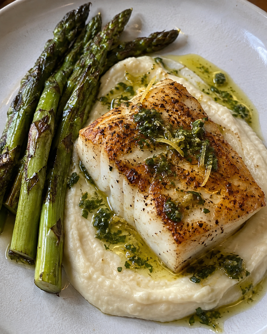 Pan-Seared Wild Halibut with Brown Butter Cauliflower Purée, Grilled Asparagus, and Lemon-Basil Oil