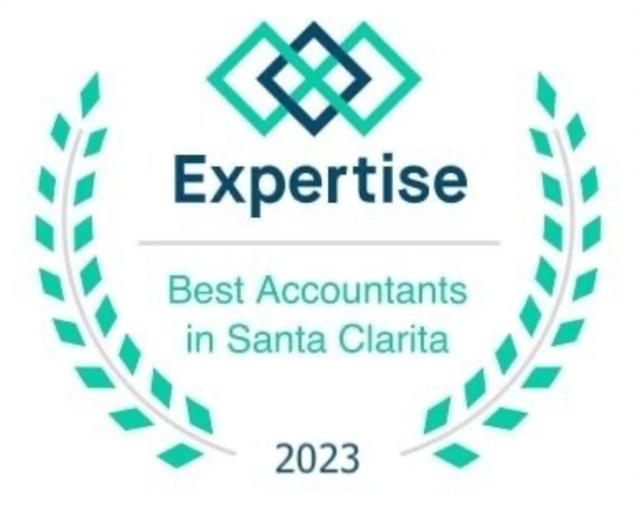 An award badge with a green laurel wreath surrounding the text. At the top, there is a geometric, interlocking diamond design in teal. Below it, text reads "Expertise" in bold, followed by "Best Accountants in Santa Clarita" and "2023" at the bottom.