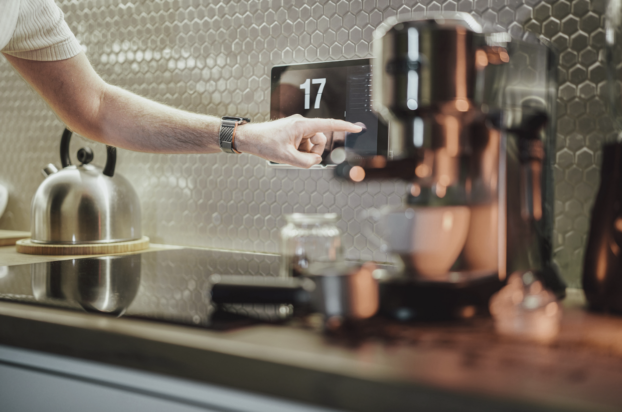 Man making coffee using a smart device