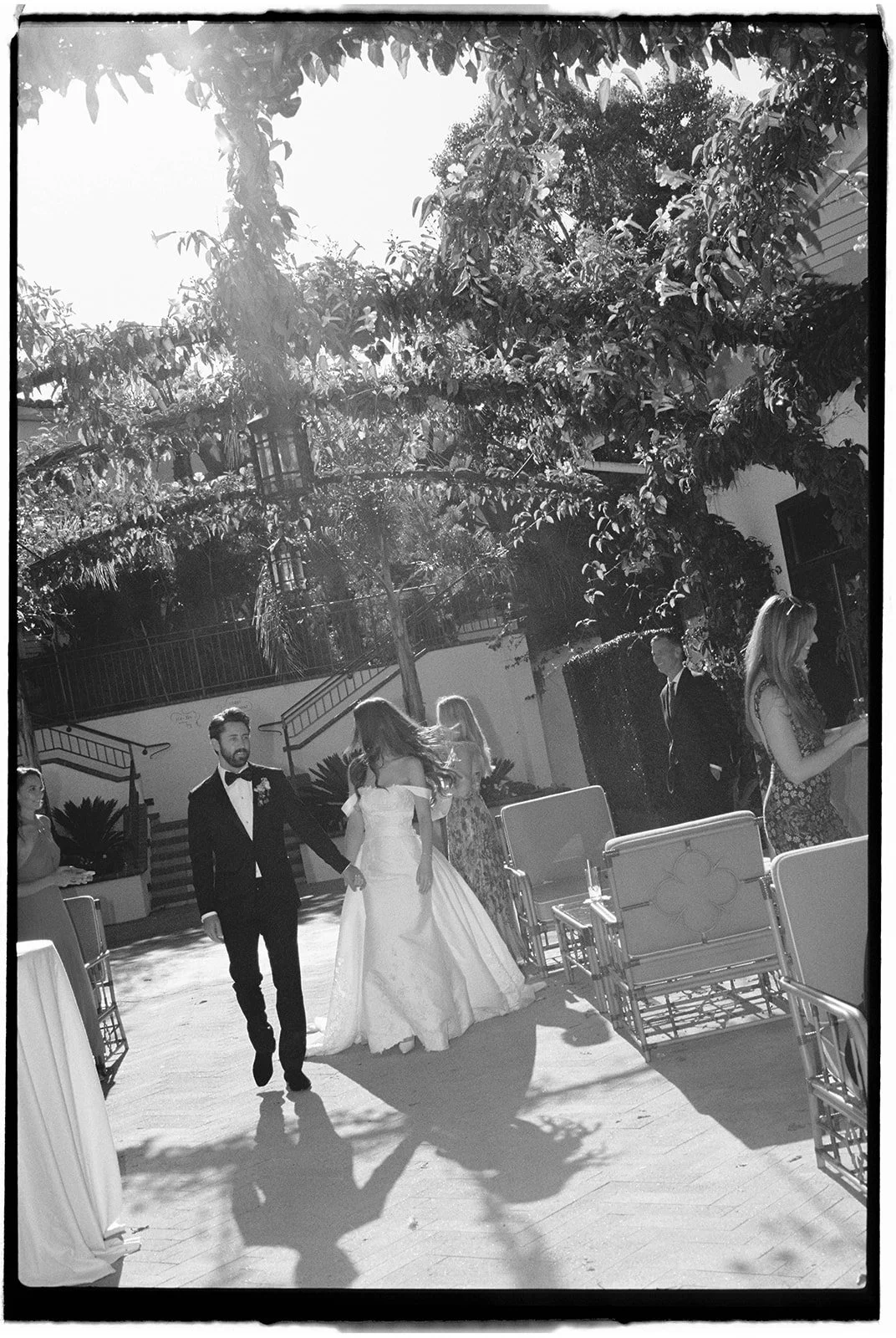  Walking into the reception as husband and wife. 35 mm film. 