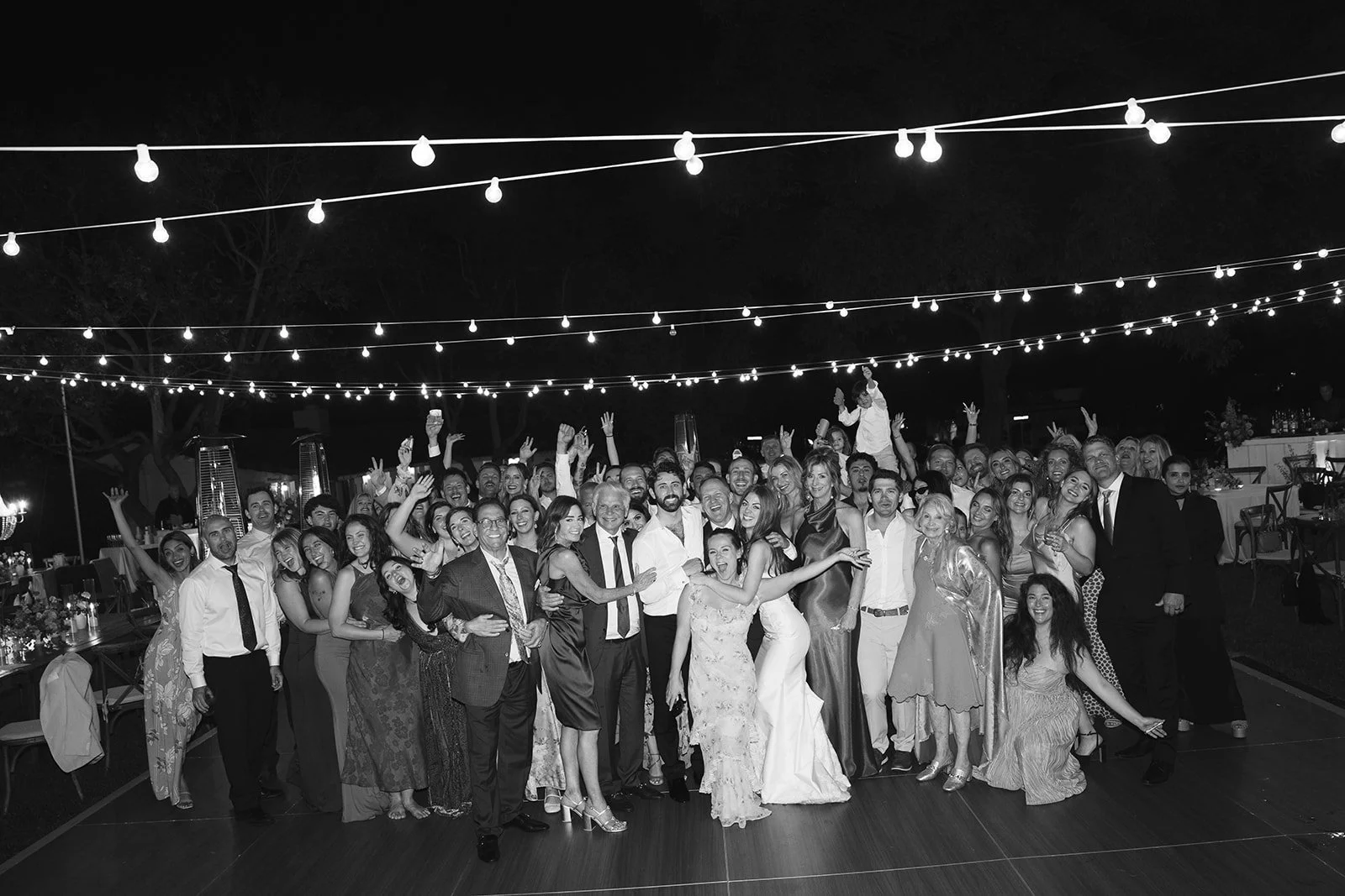  A group photo: The dance floor is packed with everyone celebrating the bride and groom. Digital. 