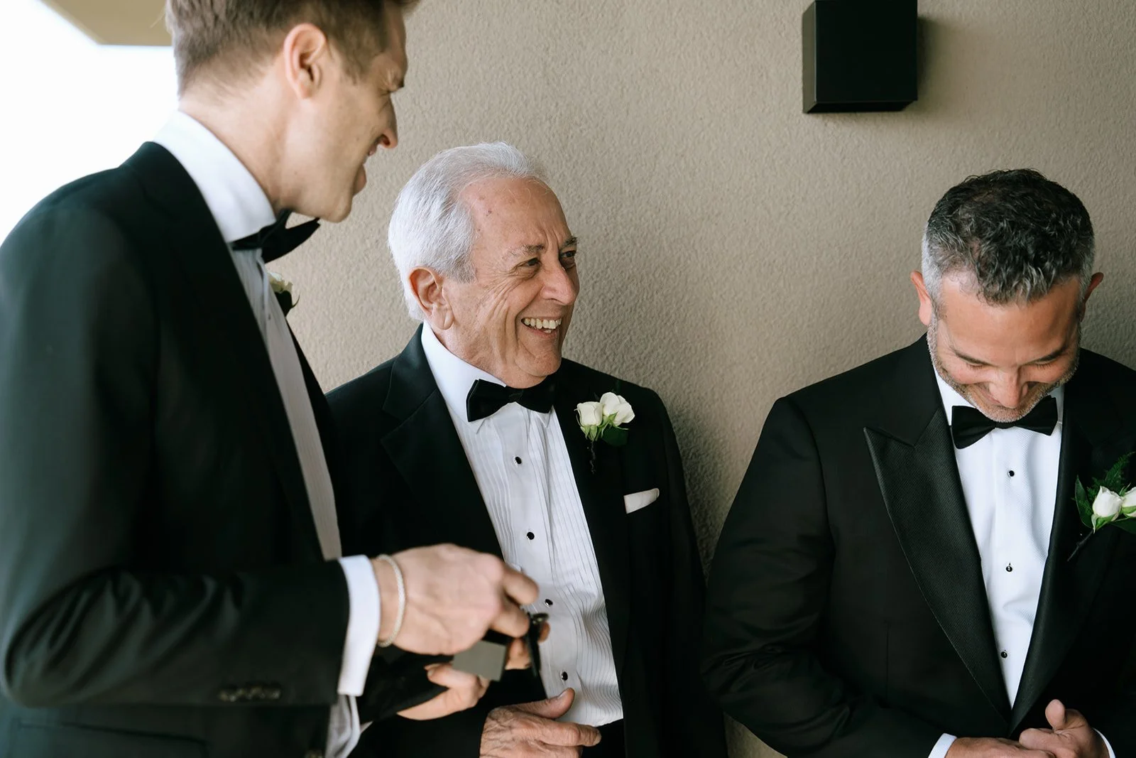 candid laughing together groom dad and groomsman