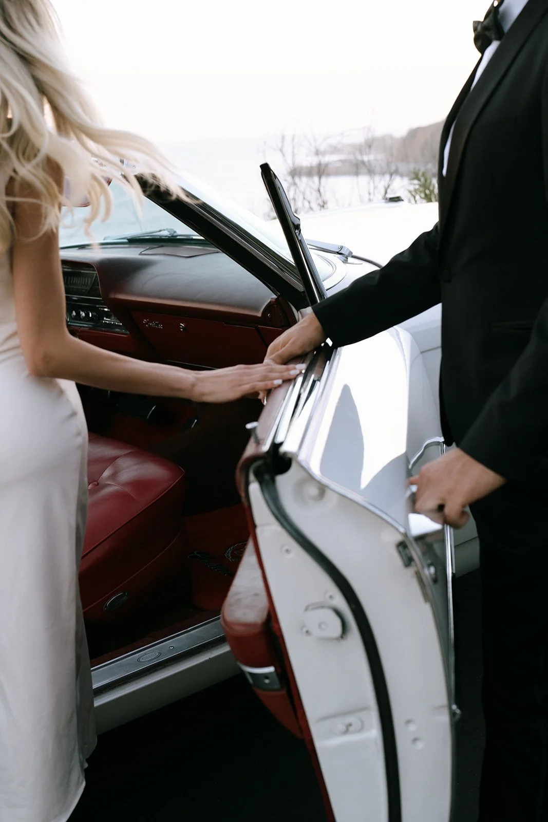 The red interior of the Cadillac as the bride gets in.