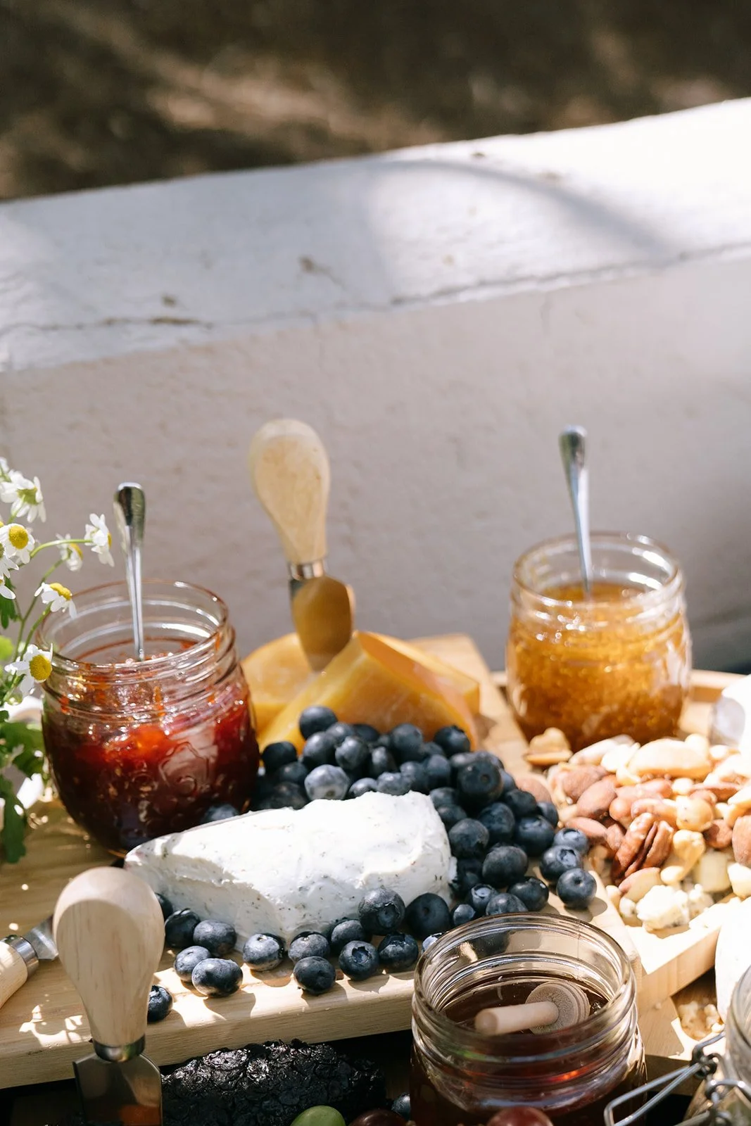 Detail shot of colorful jam, fruit, honey, and cheese spread for a Mediterranean inspired wedding dinner