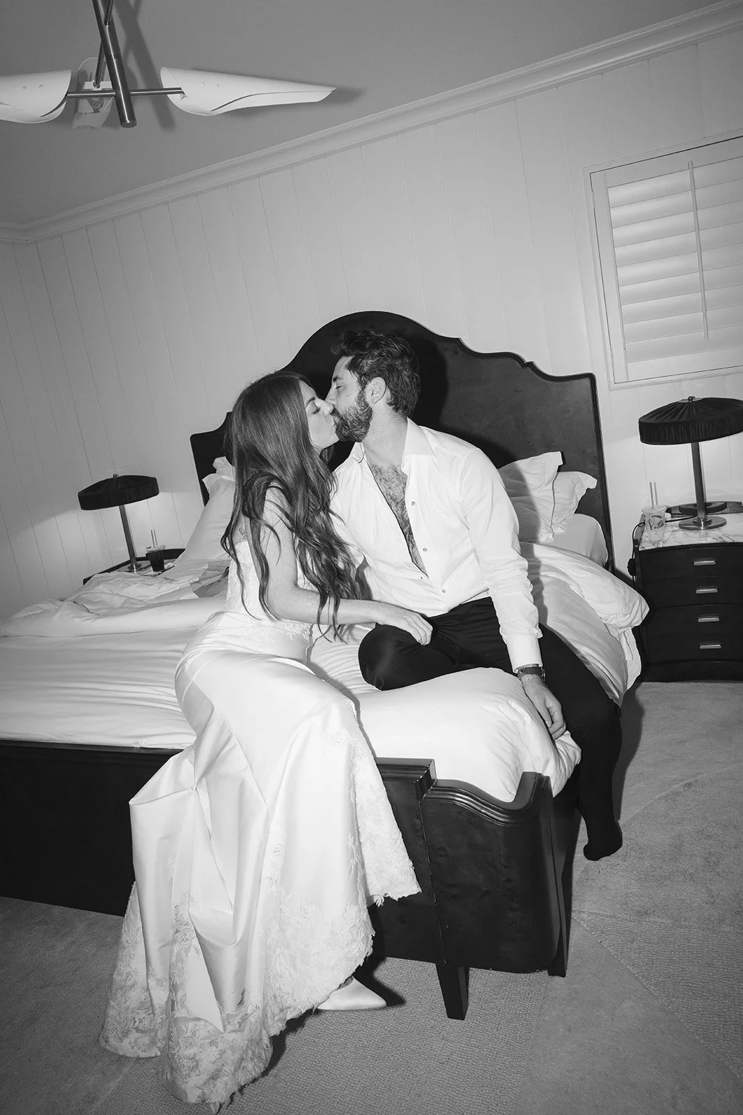  The bride and groom sharing one last kiss in their hotel room to end the wedding night. 
