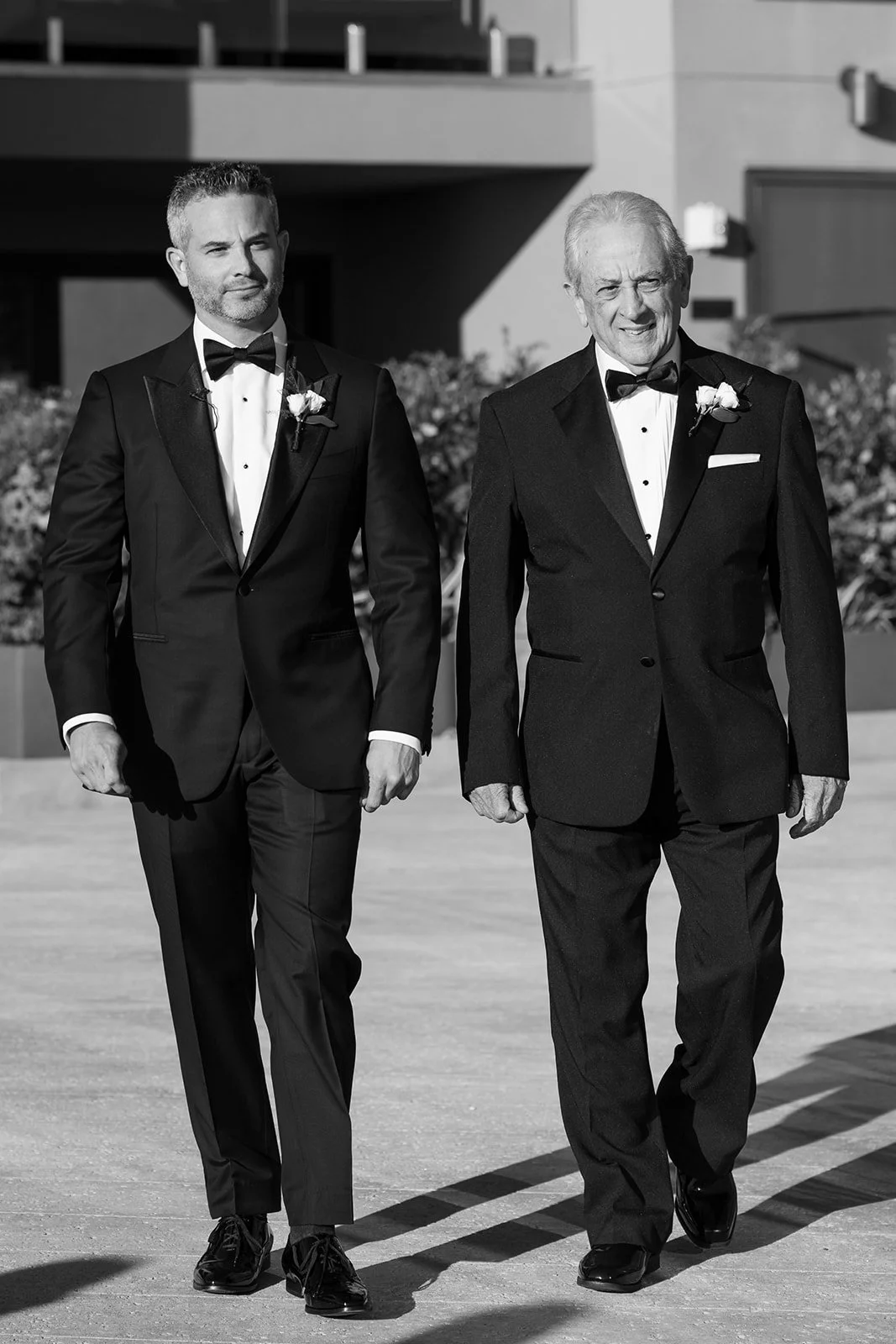 groom walks down the aisle in tuxedos at wedding luxury resort venue